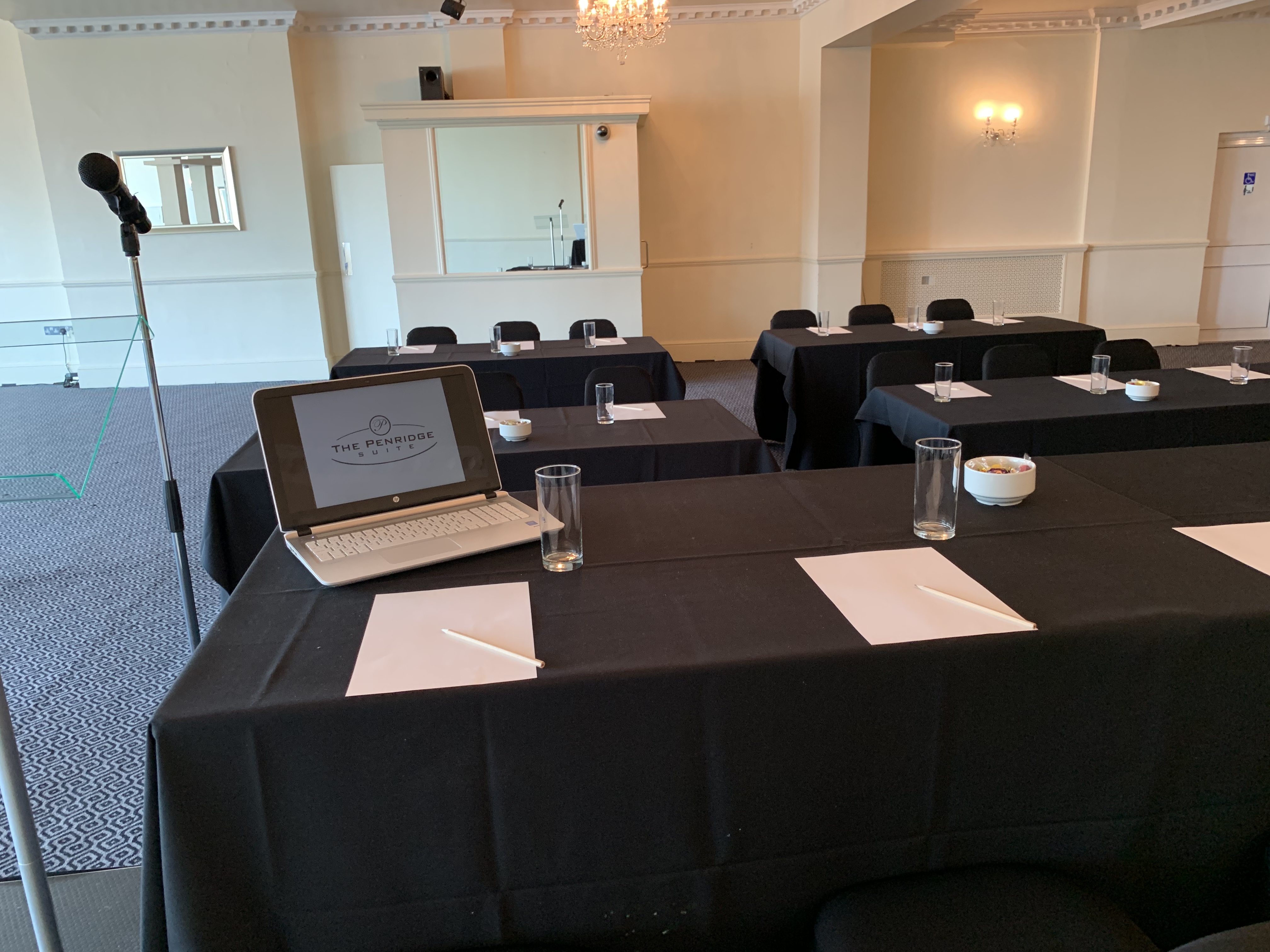 Wedding Hall Suite with sleek black tablecloths for professional meetings and presentations.