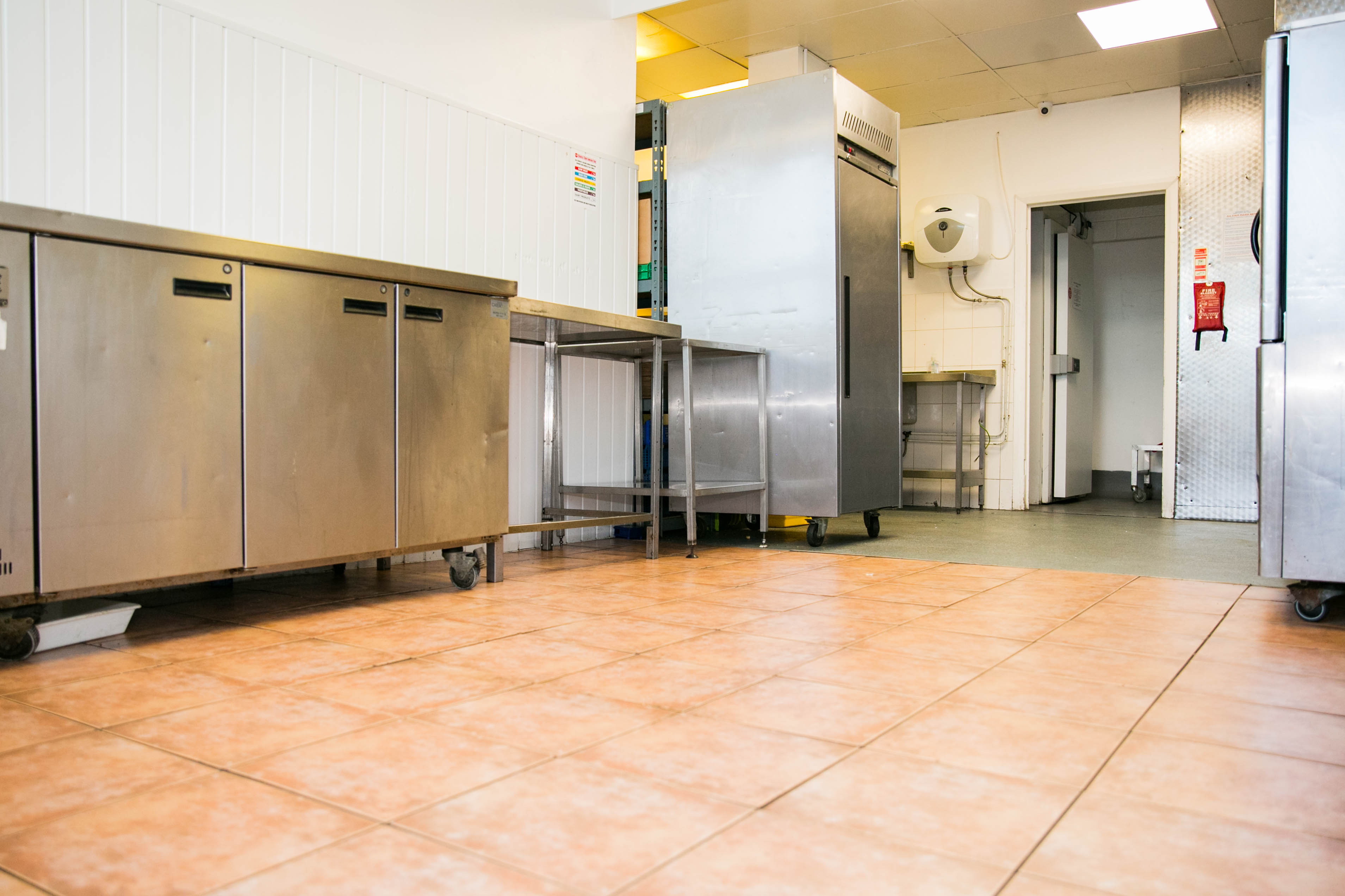 Commercial kitchen at The Olive Grows Ltd with stainless steel appliances for event catering.