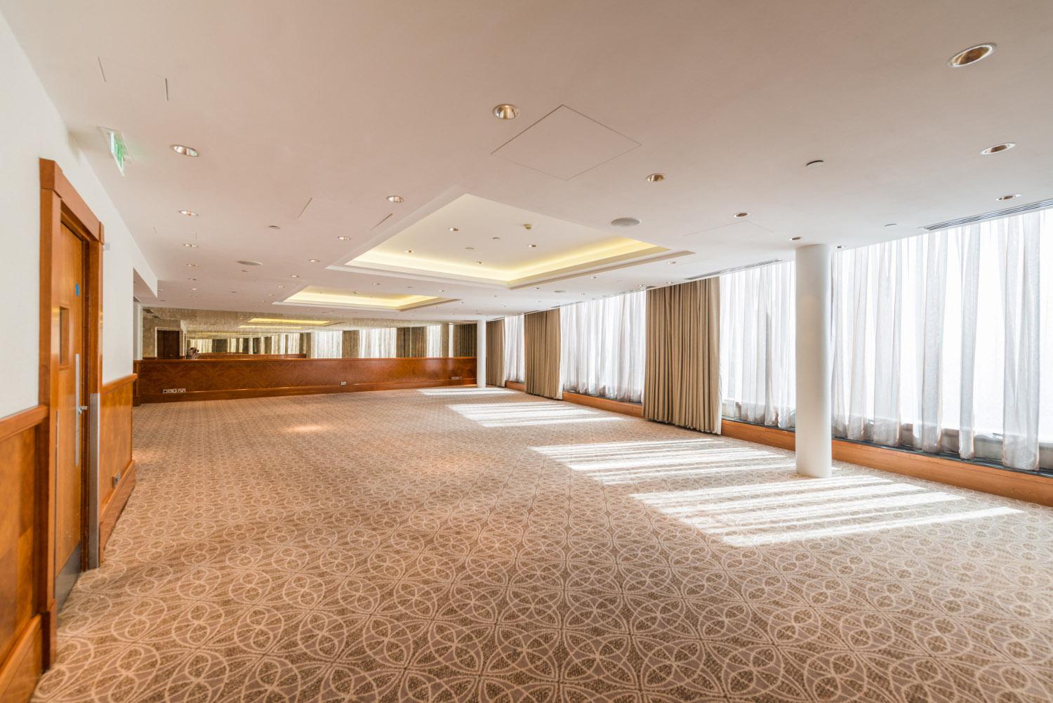 York Suite at Royal Garden Hotel, spacious event room with large windows for meetings.