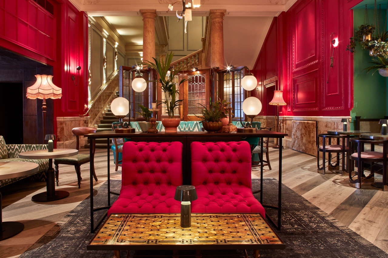 Stylish Rakes Parlor event space with bold red walls, ideal for networking and gatherings.