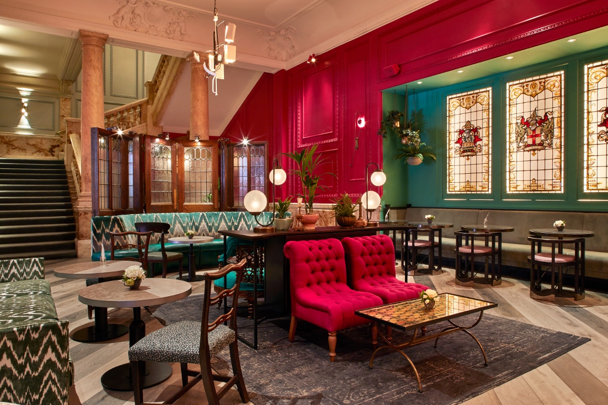 Rakes Parlor event space in Andaz London, featuring vibrant colors and elegant stained glass.