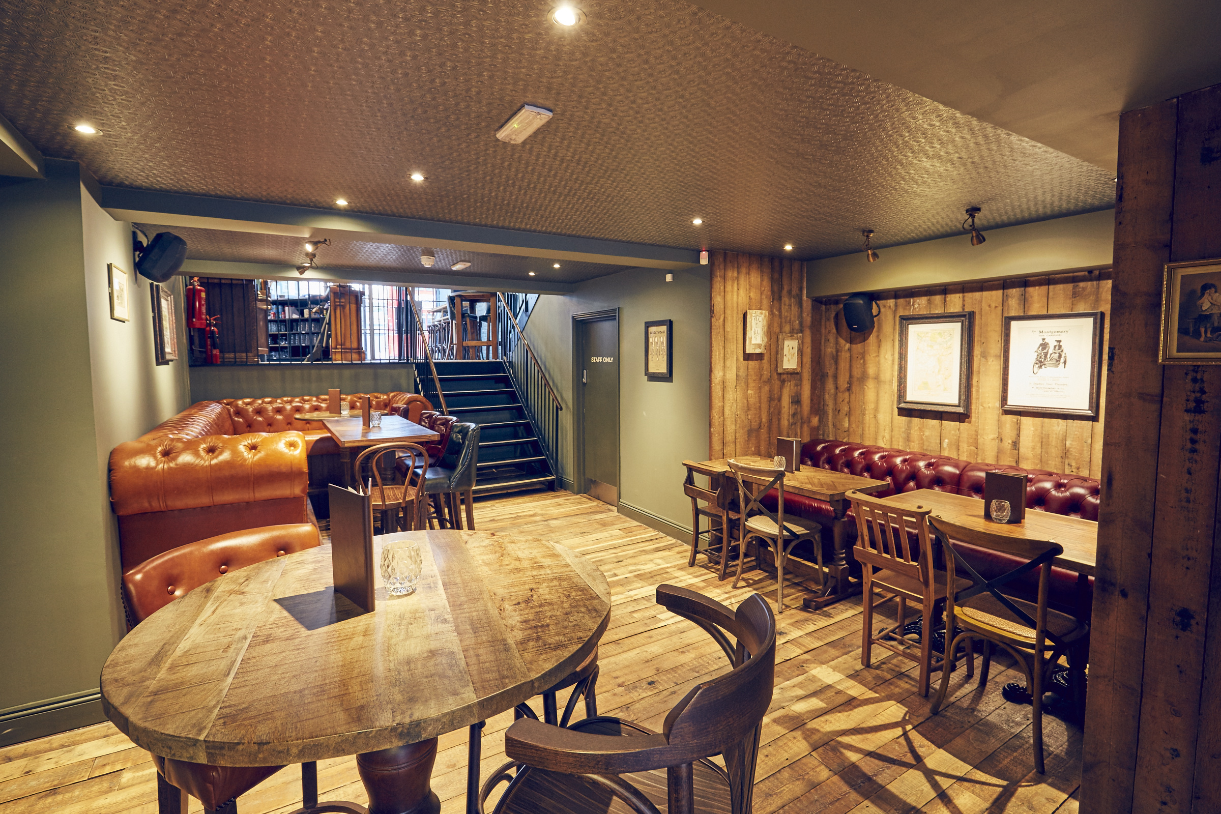 Cozy East Putney Tavern downstairs area with plush seating for casual events and networking.