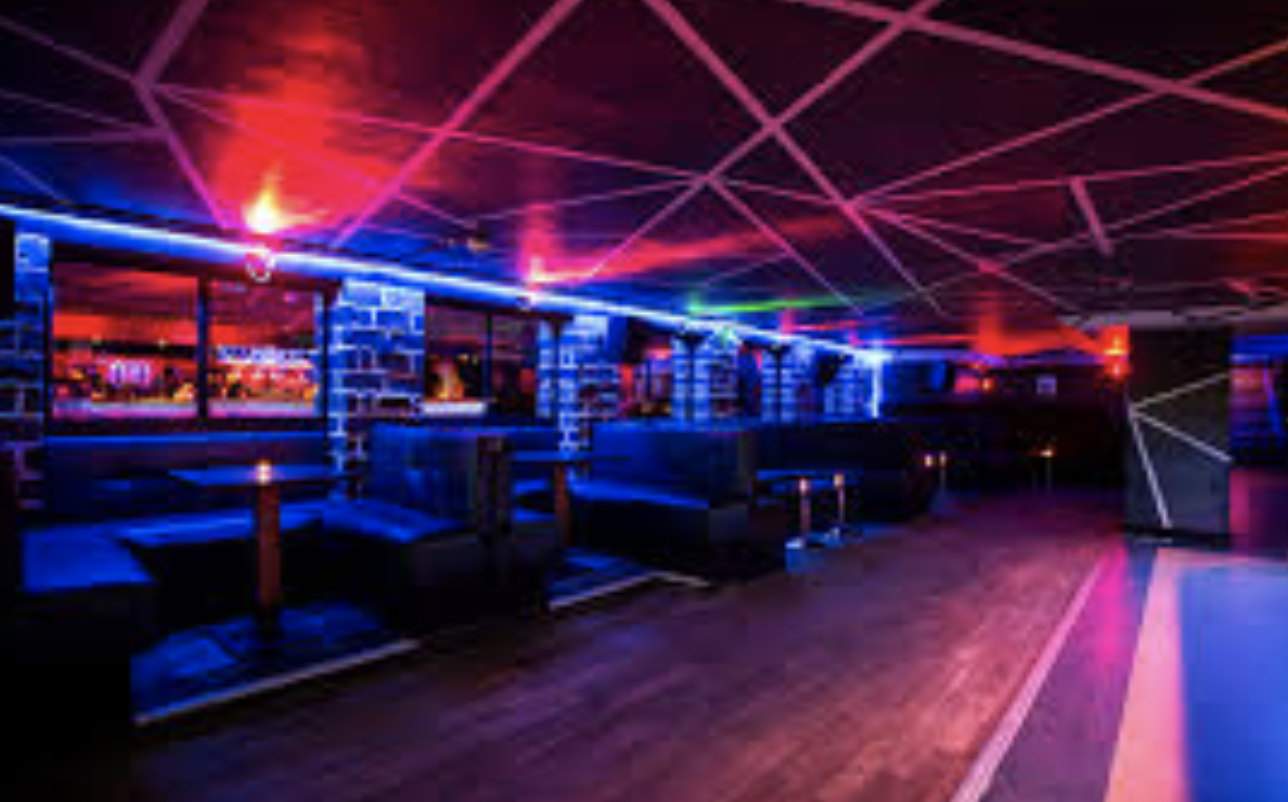 Modern dance bar with vibrant blue lighting, perfect for networking events and social gatherings.