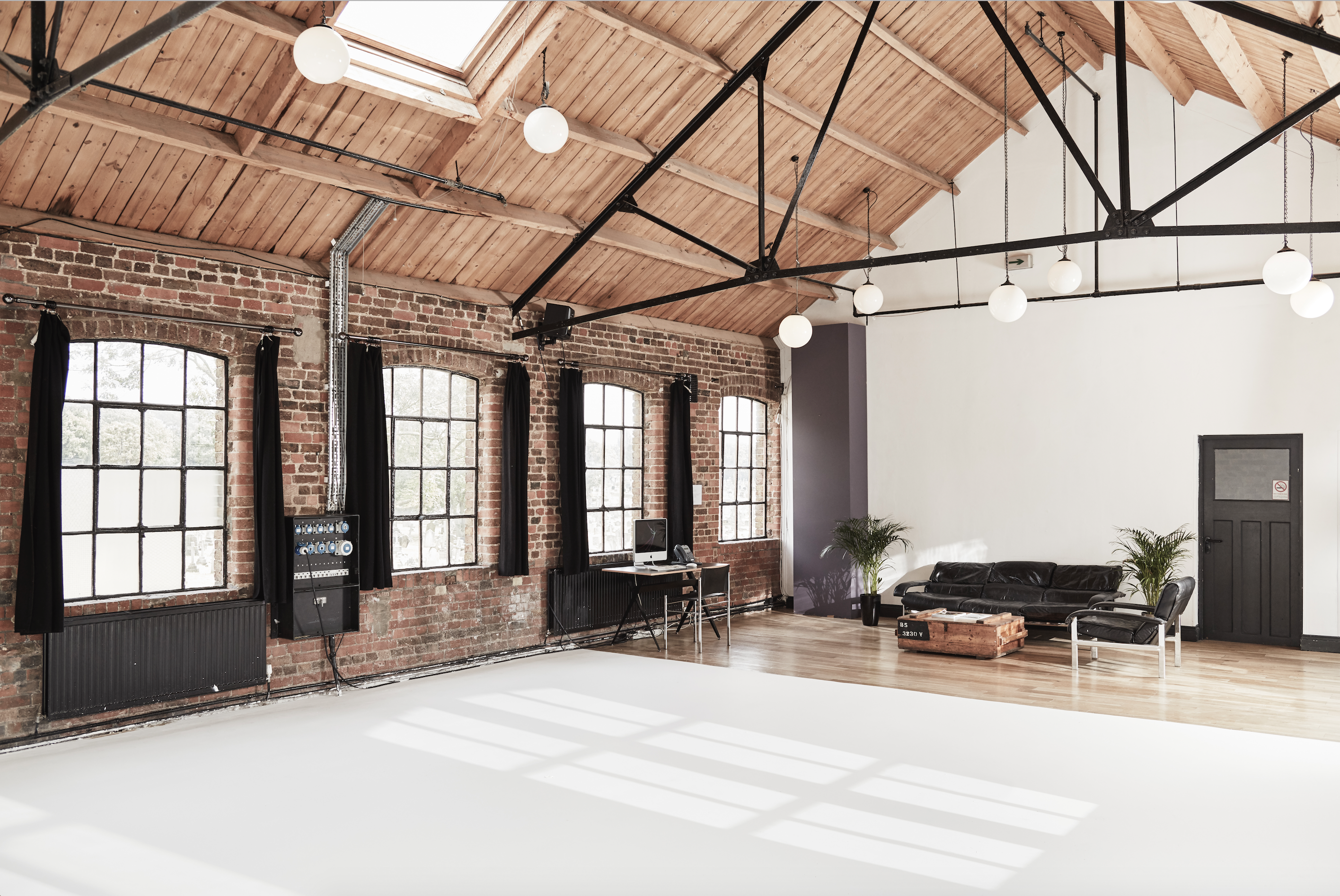 Spacious, well-lit event space with exposed brick for meetings and workshops.