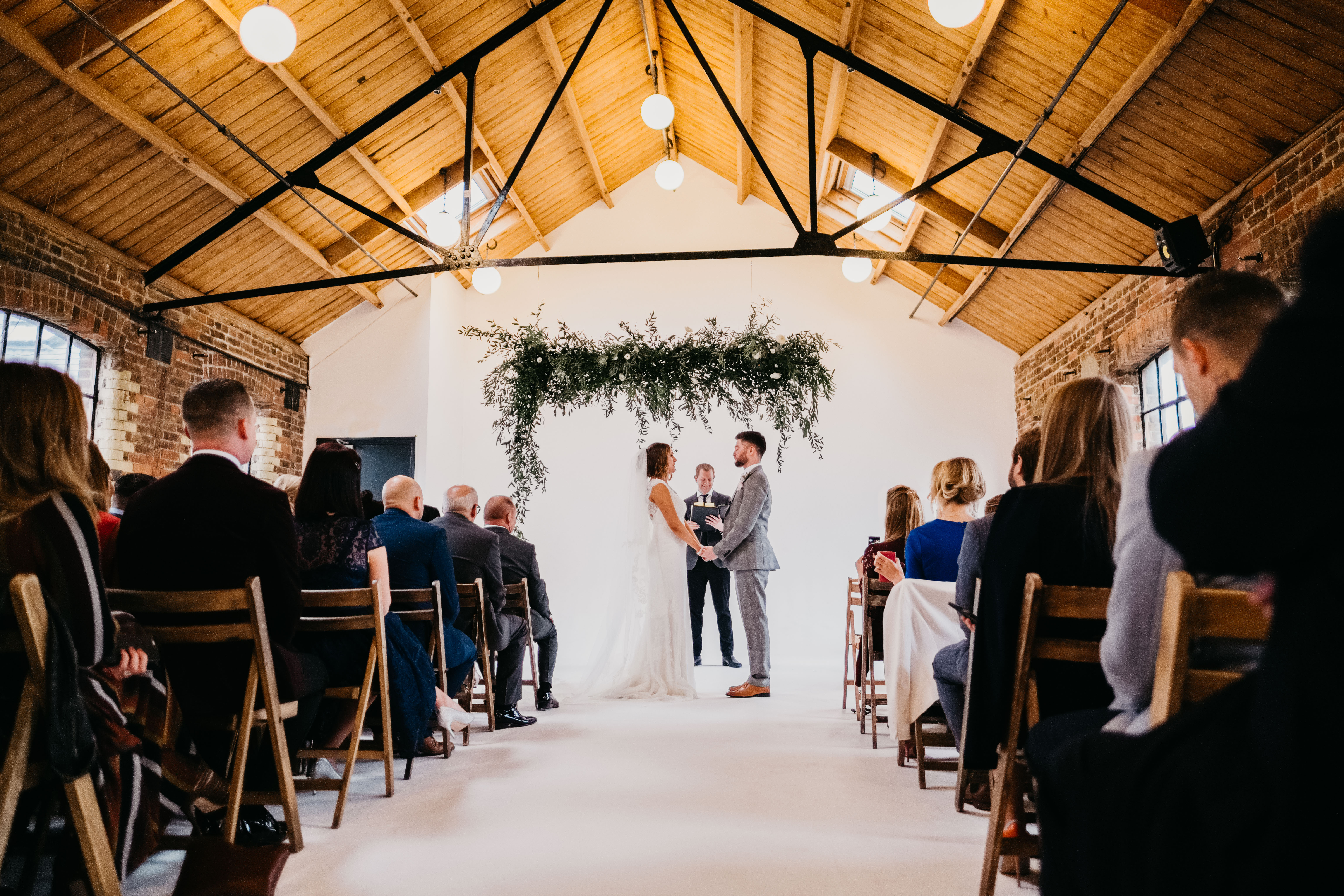 Rustic wedding ceremony setup with floral backdrop at Loft Studios, ideal for events.