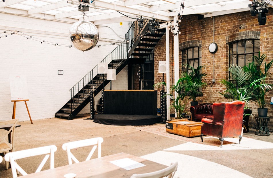 Versatile Loft Studios event space with stage, ideal for corporate meetings and performances.