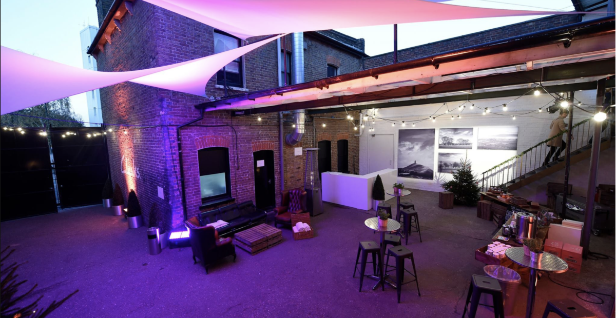 Stylish outdoor event space with ambient lighting for networking and social gatherings.