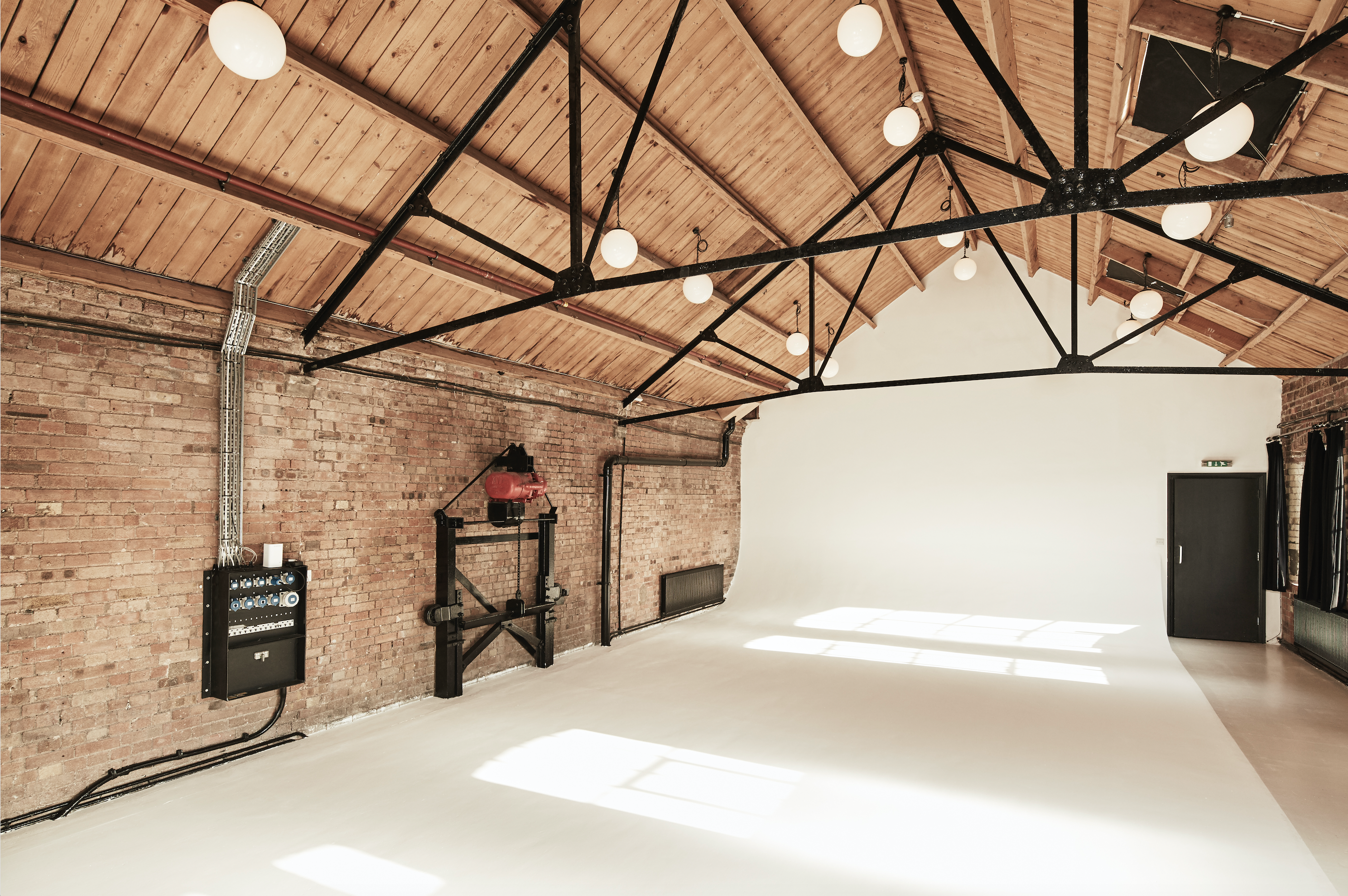 Versatile Loft Studios event space with exposed brick walls, ideal for workshops and presentations.