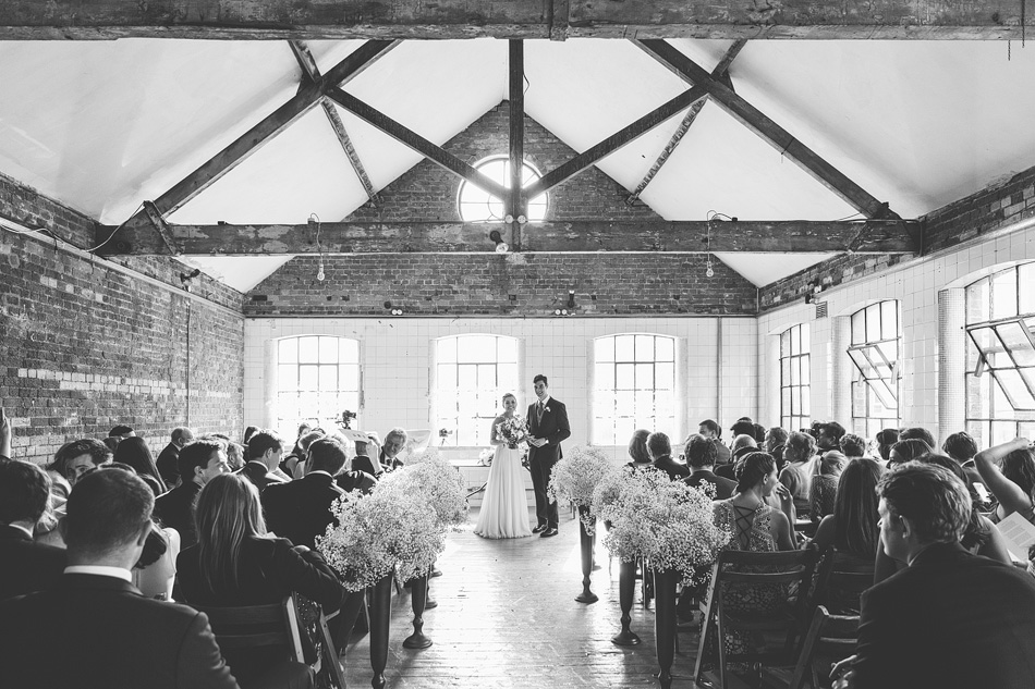 Wedding ceremony setup in Loft Studios' Studio 4 with exposed brick and floral elegance.