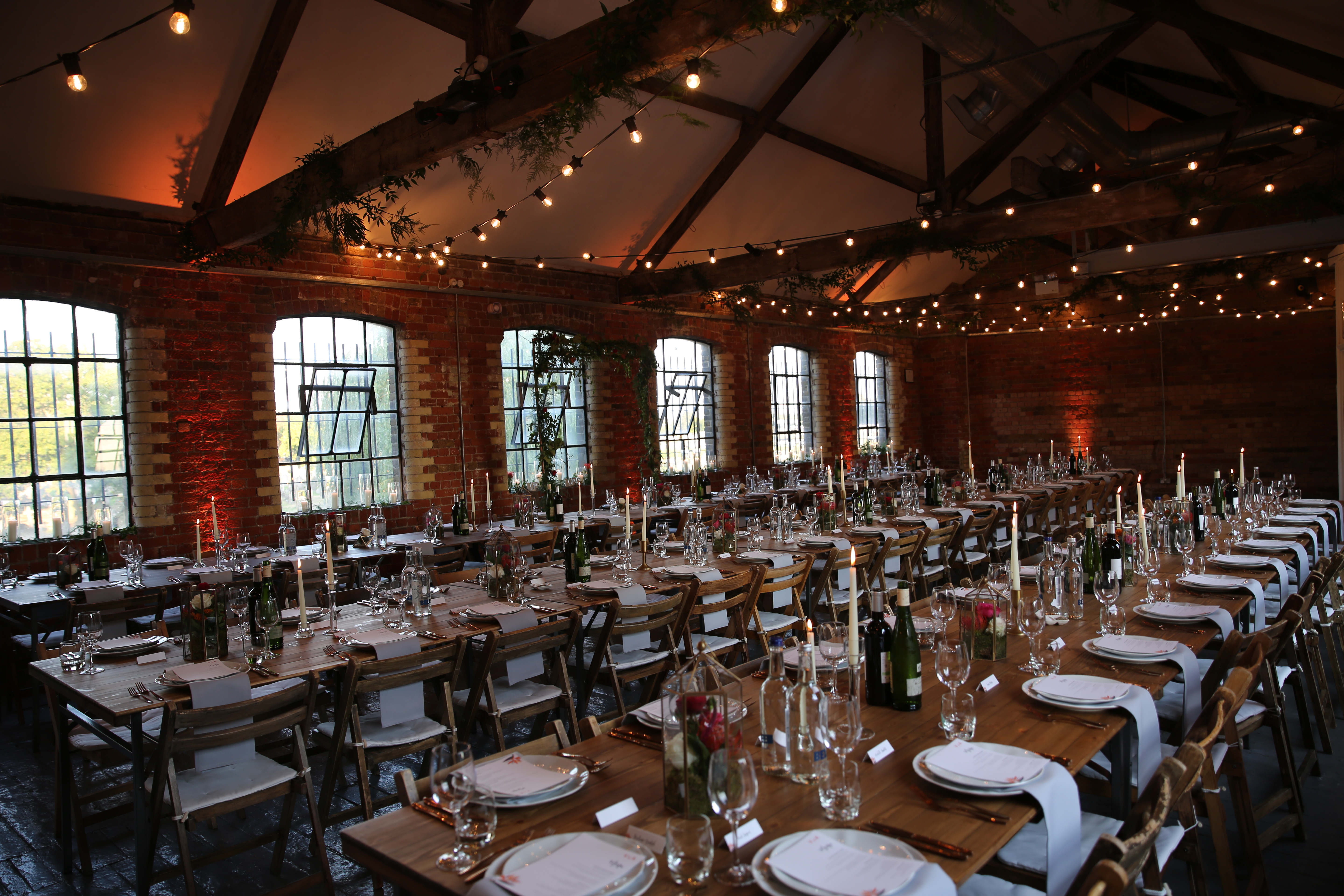 Elegant event space in Loft Studios with candlelit tables for sophisticated dinners.