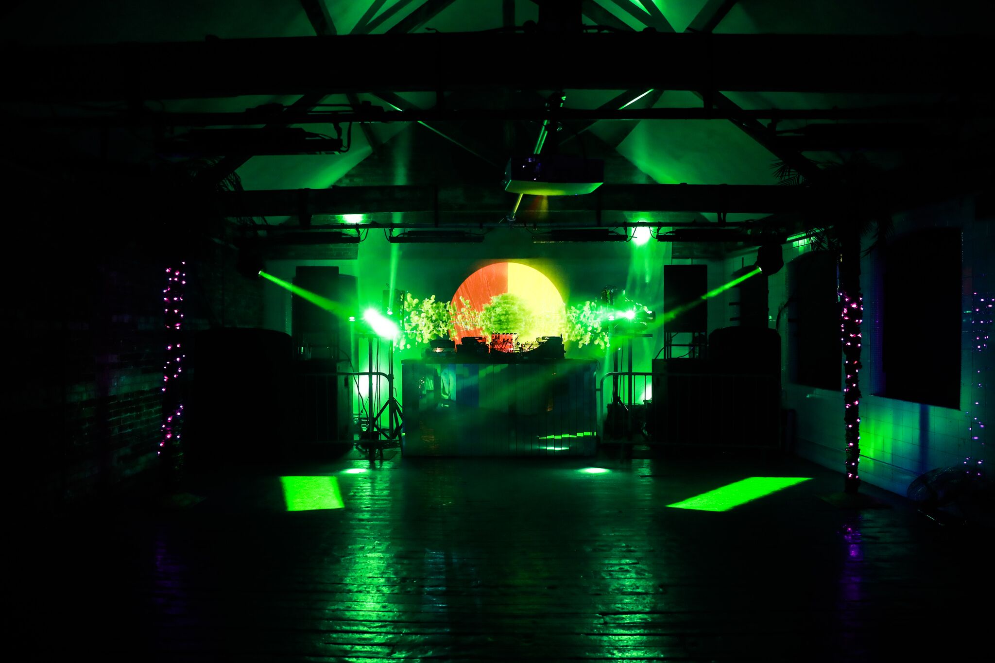 Dynamic event space in Loft Studios with vibrant green lighting for concerts or parties.