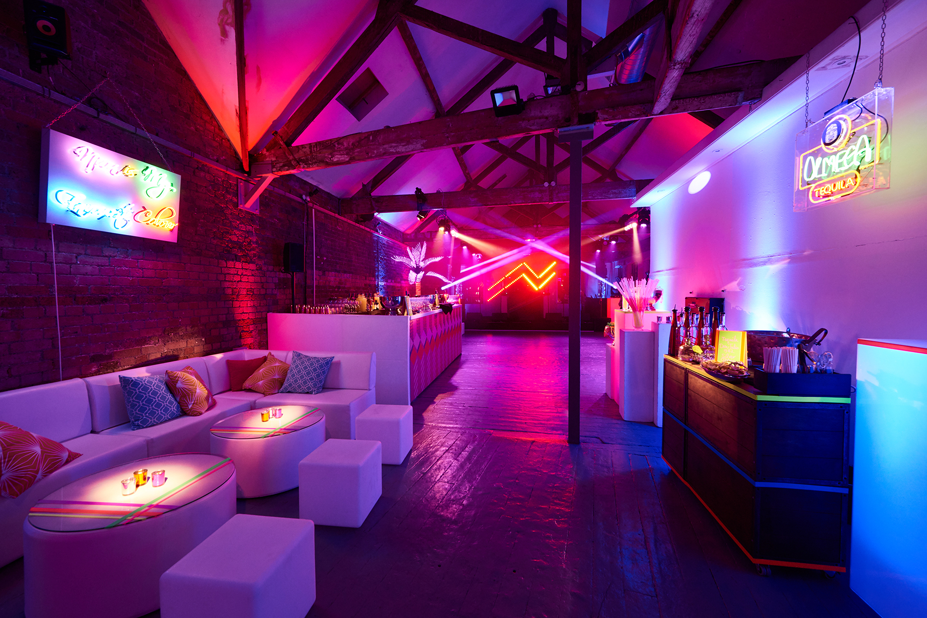 Vibrant event space with neon lighting, perfect for trendy parties and corporate gatherings.