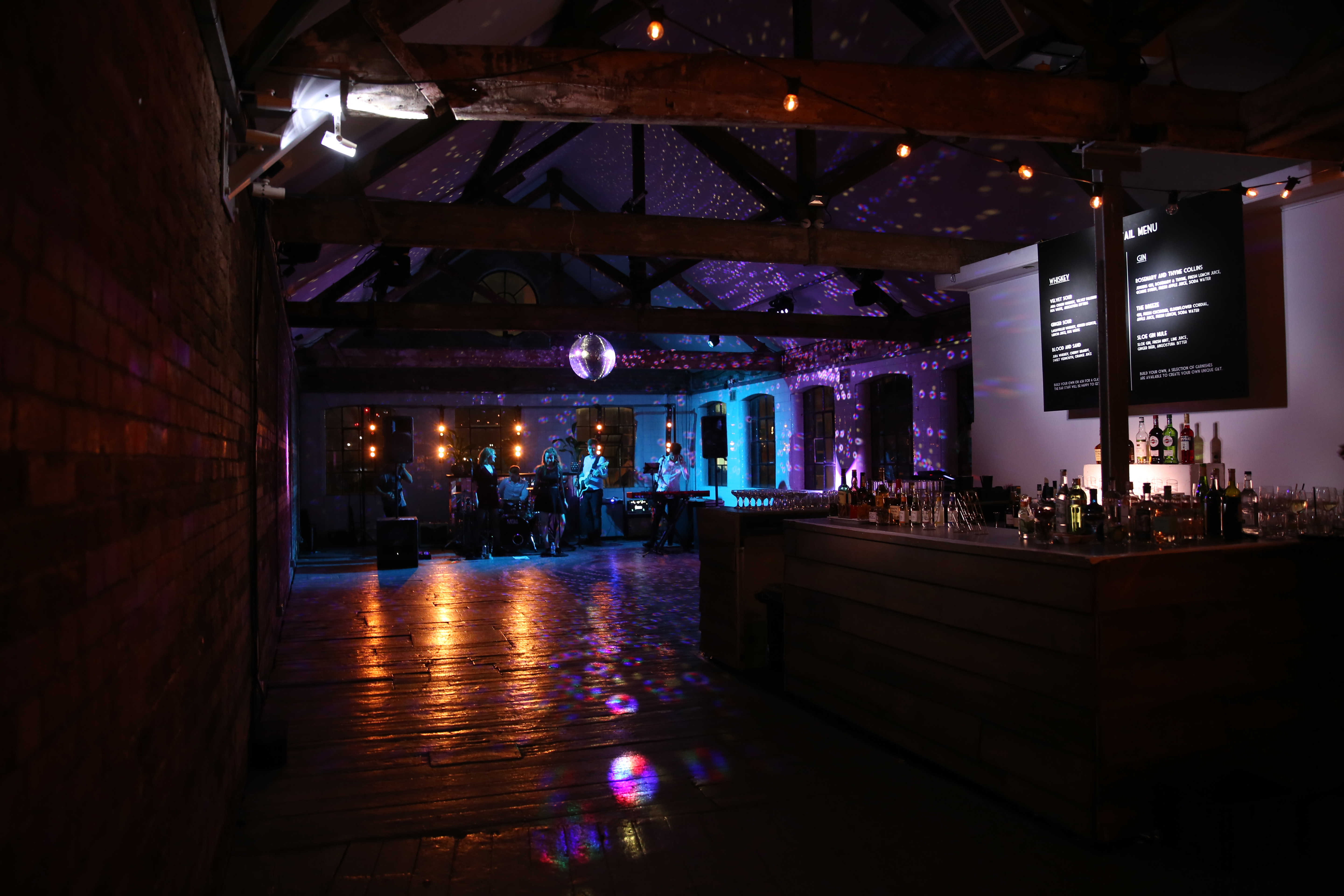 Stylish Loft Studios event space with disco ball, perfect for corporate and social gatherings.