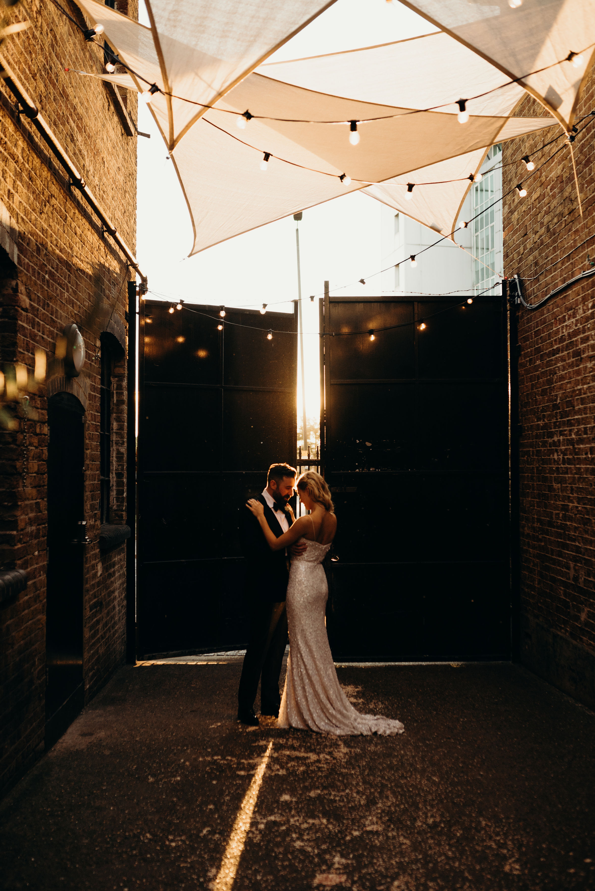 Couple embracing in Daylight Courtyard, Loft Studios, perfect for romantic weddings.
