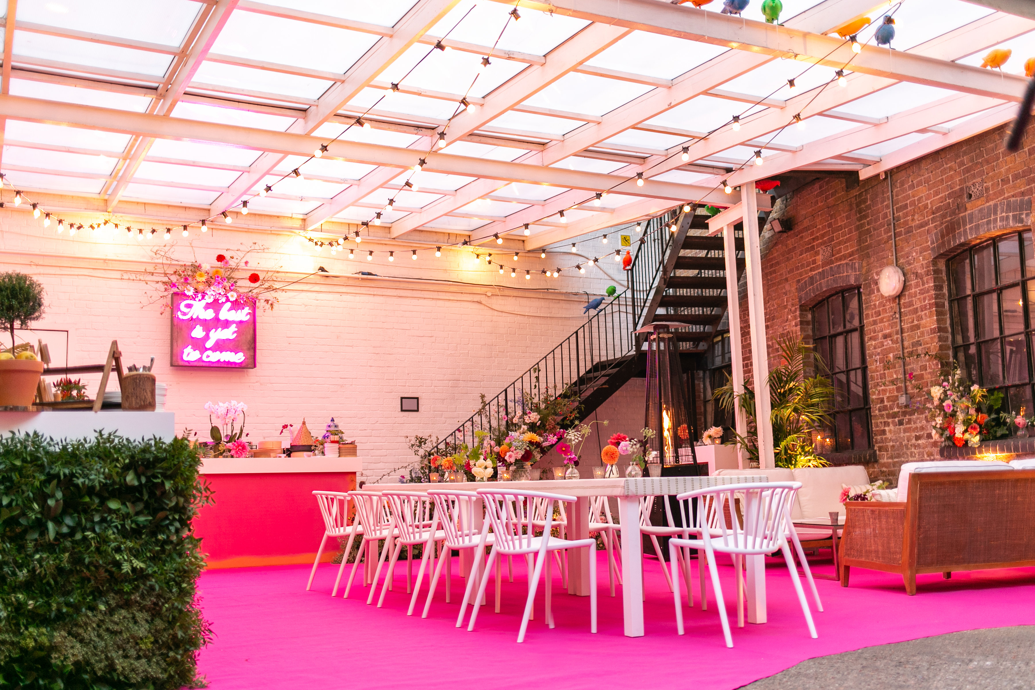 Vibrant Loft Studios event space with pink carpet and elegant decor for gatherings.