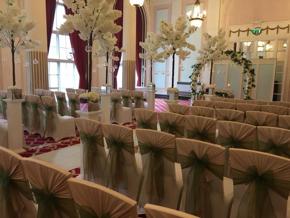 Derby Suite at The Adelphi Hotel, elegant wedding ceremony with white chairs and floral decor.