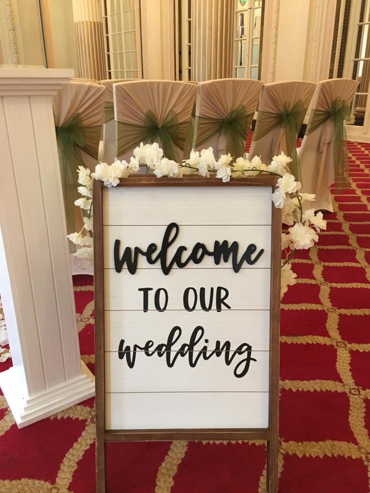 Elegant wedding welcome sign with floral accents at The Adelphi Hotel's Derby Suite.