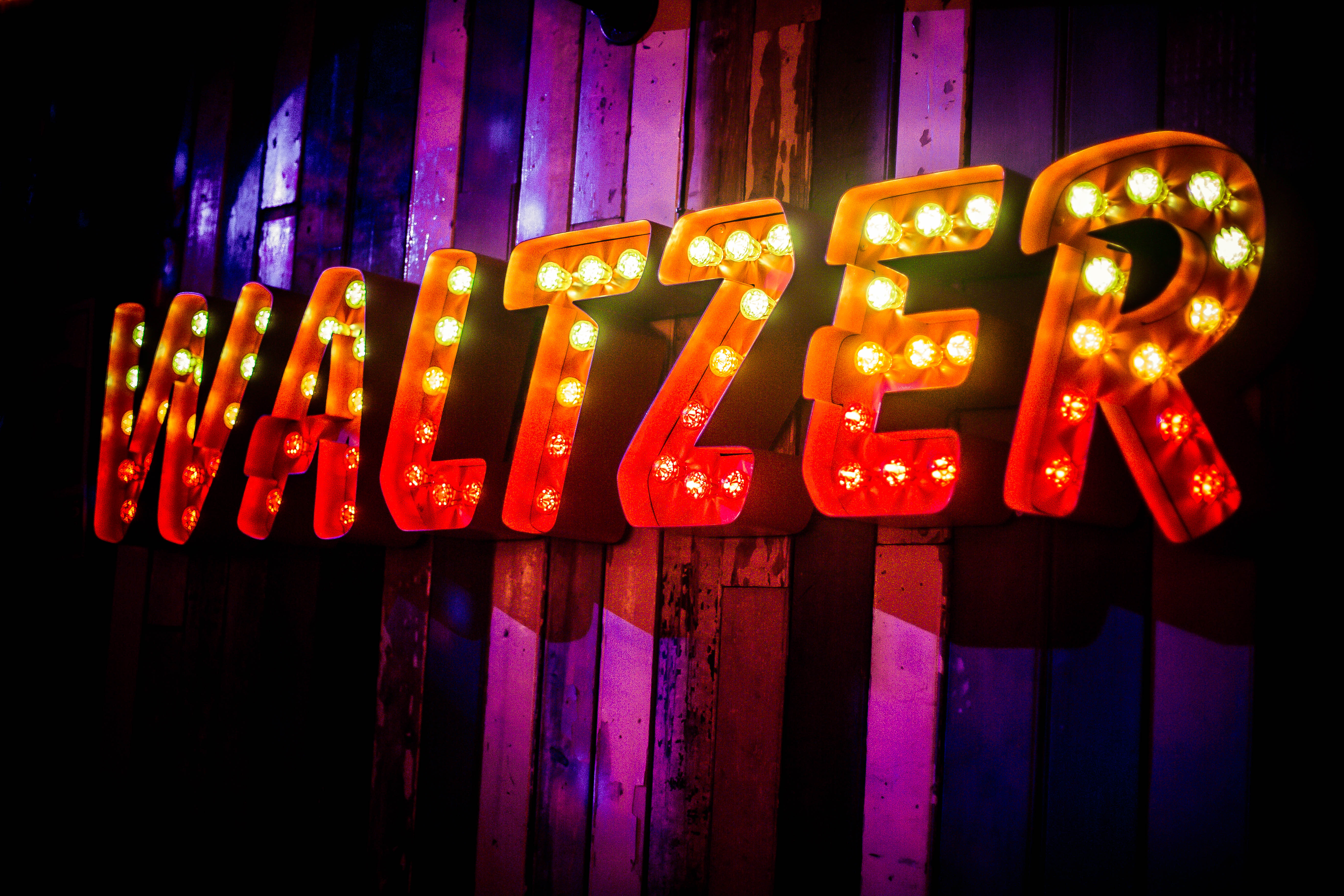 "Vibrant 'WALTZER' sign at Simmons Oxford Street for festive events and gatherings."