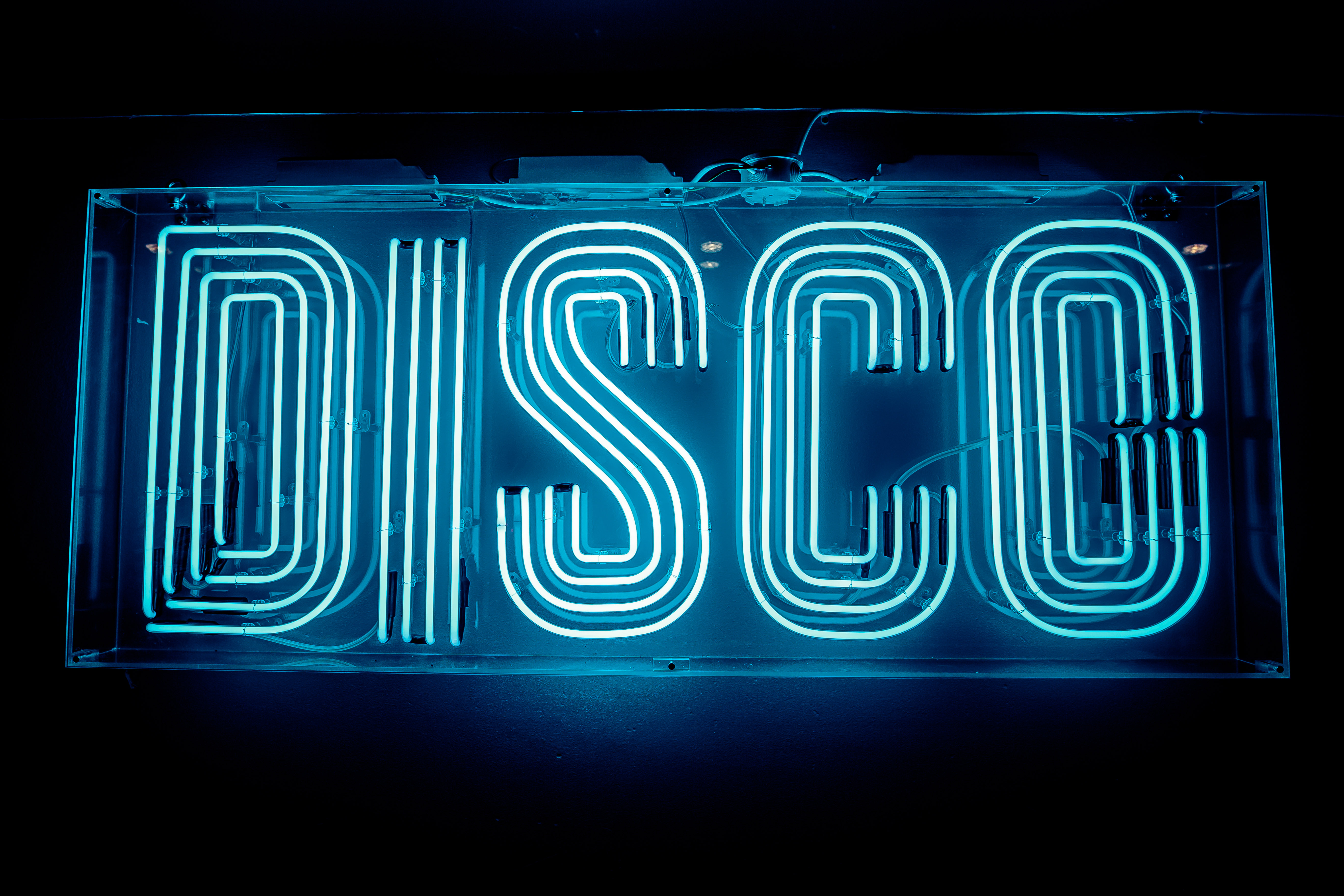 Vibrant neon "DISCO" sign at Simmons Oxford Street for themed parties and events.