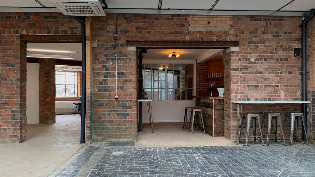 Private Bar in Iron House: versatile event space with exposed brick, ideal for networking and workshops.