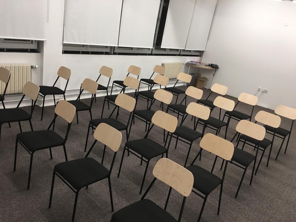 Seminar Room in Whitechapel Hub with minimalist chairs for workshops and meetings.