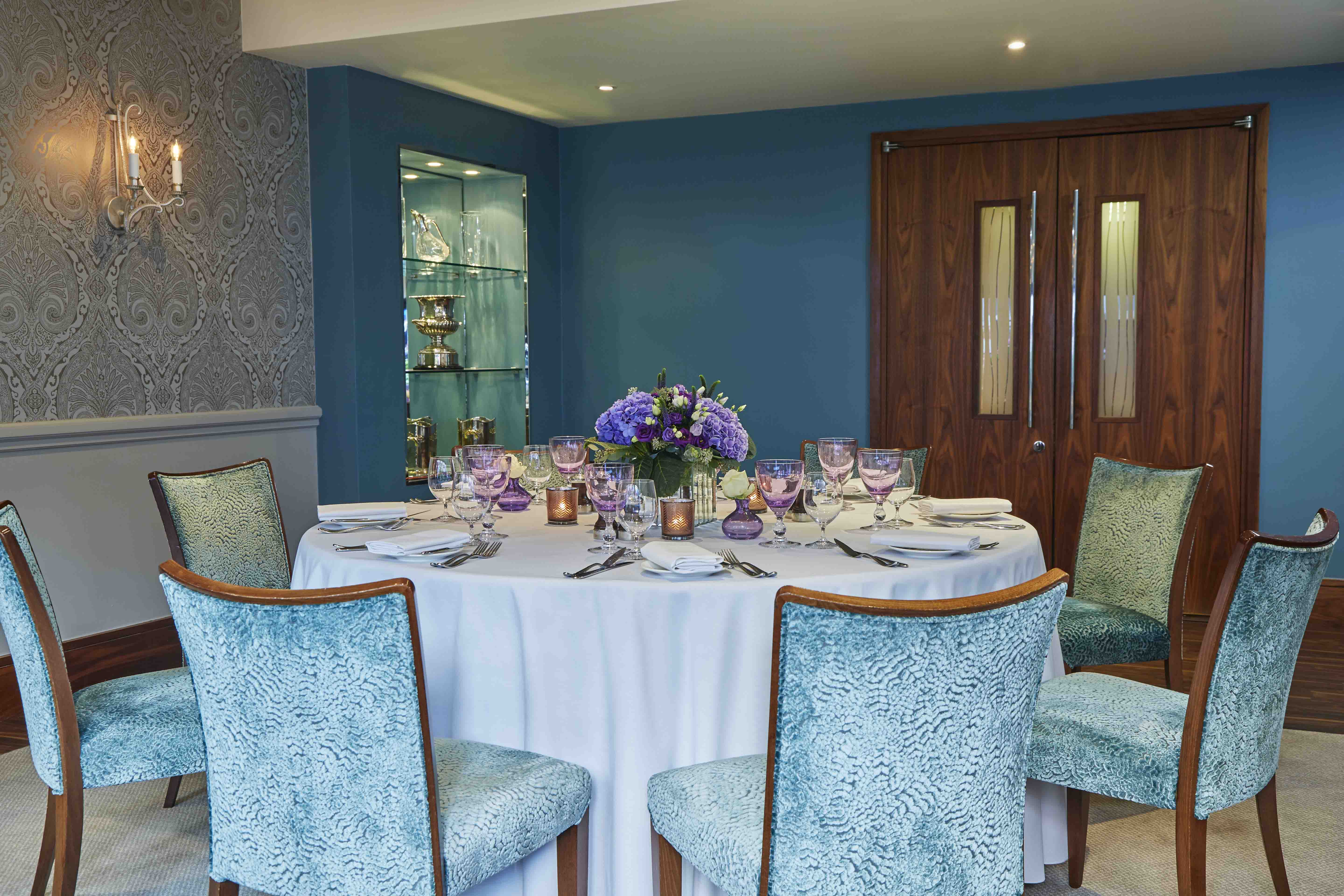 Eaton suite at The Capital Hotel: elegant meeting space with floral centerpiece for upscale events.