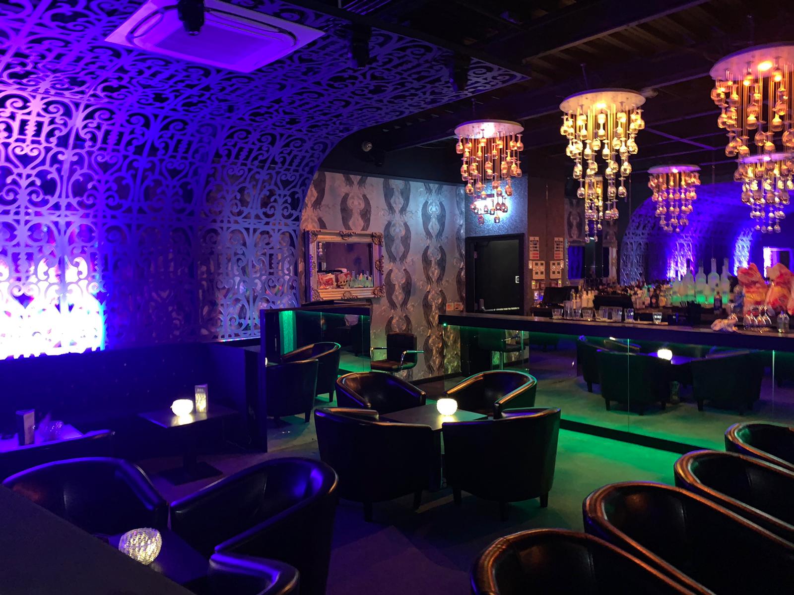 Stylish Black Diamond Gentleman's Club event space with elegant chandeliers for cocktail receptions.