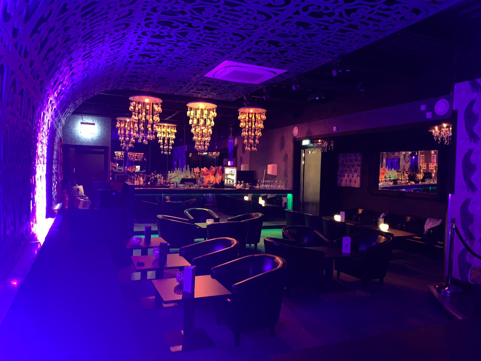 Elegant event space at Black Diamond Gentleman's Club with chandeliers for cocktail receptions.