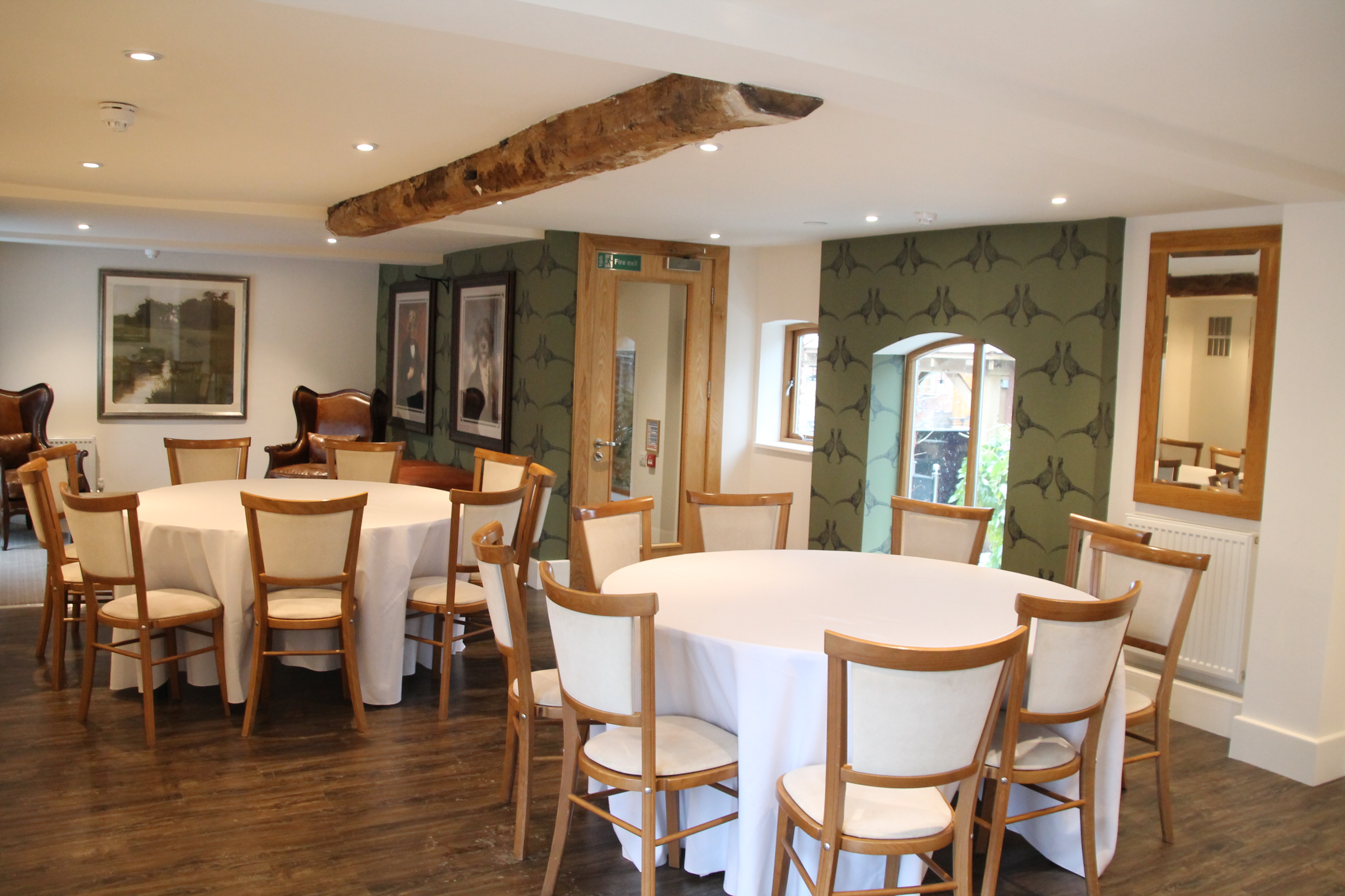 Elegant Mythe Barn stable meeting space with natural light, perfect for workshops and events.
