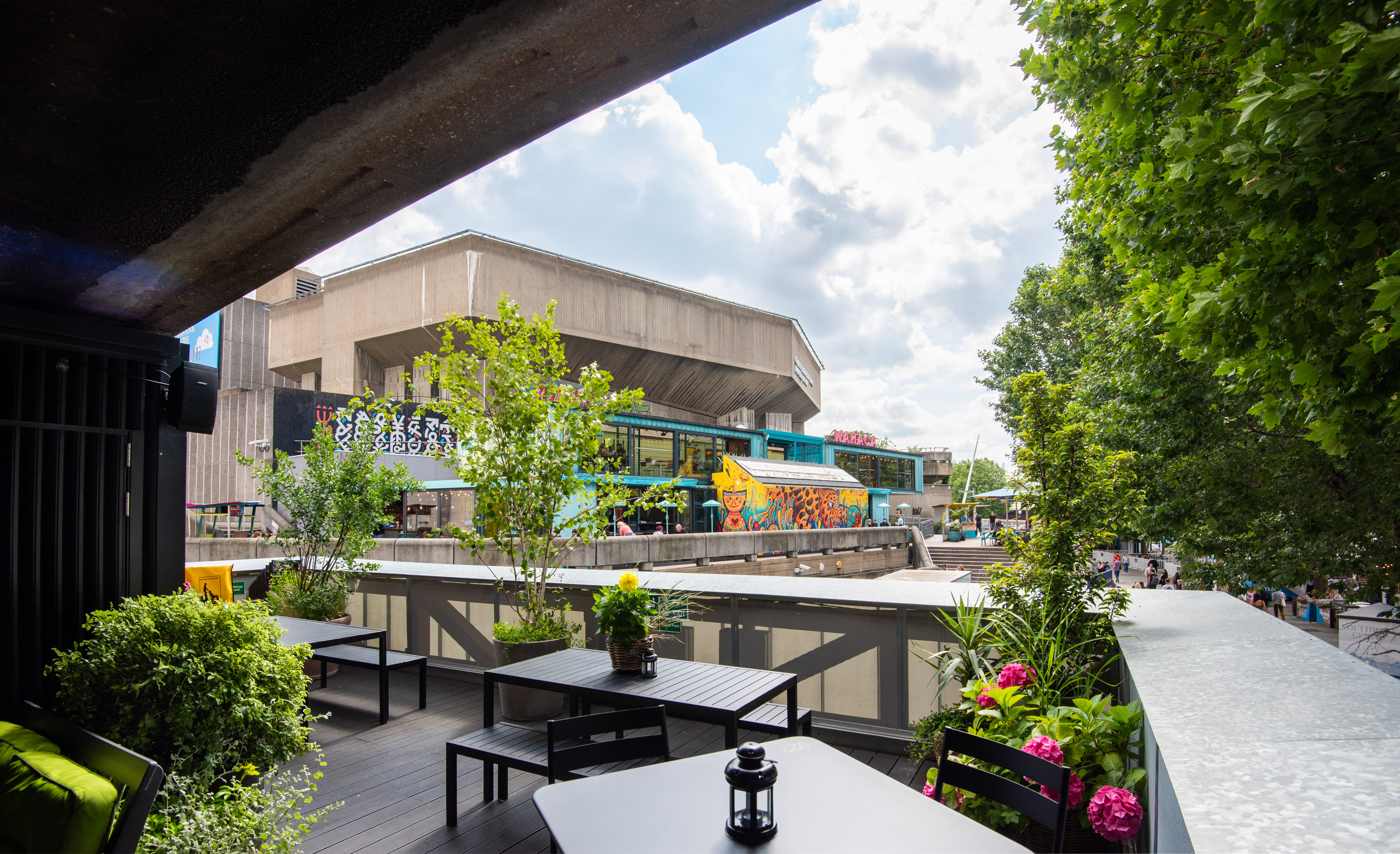 Vibrant Balcony Bar with lush greenery, ideal for casual meetings and networking events.