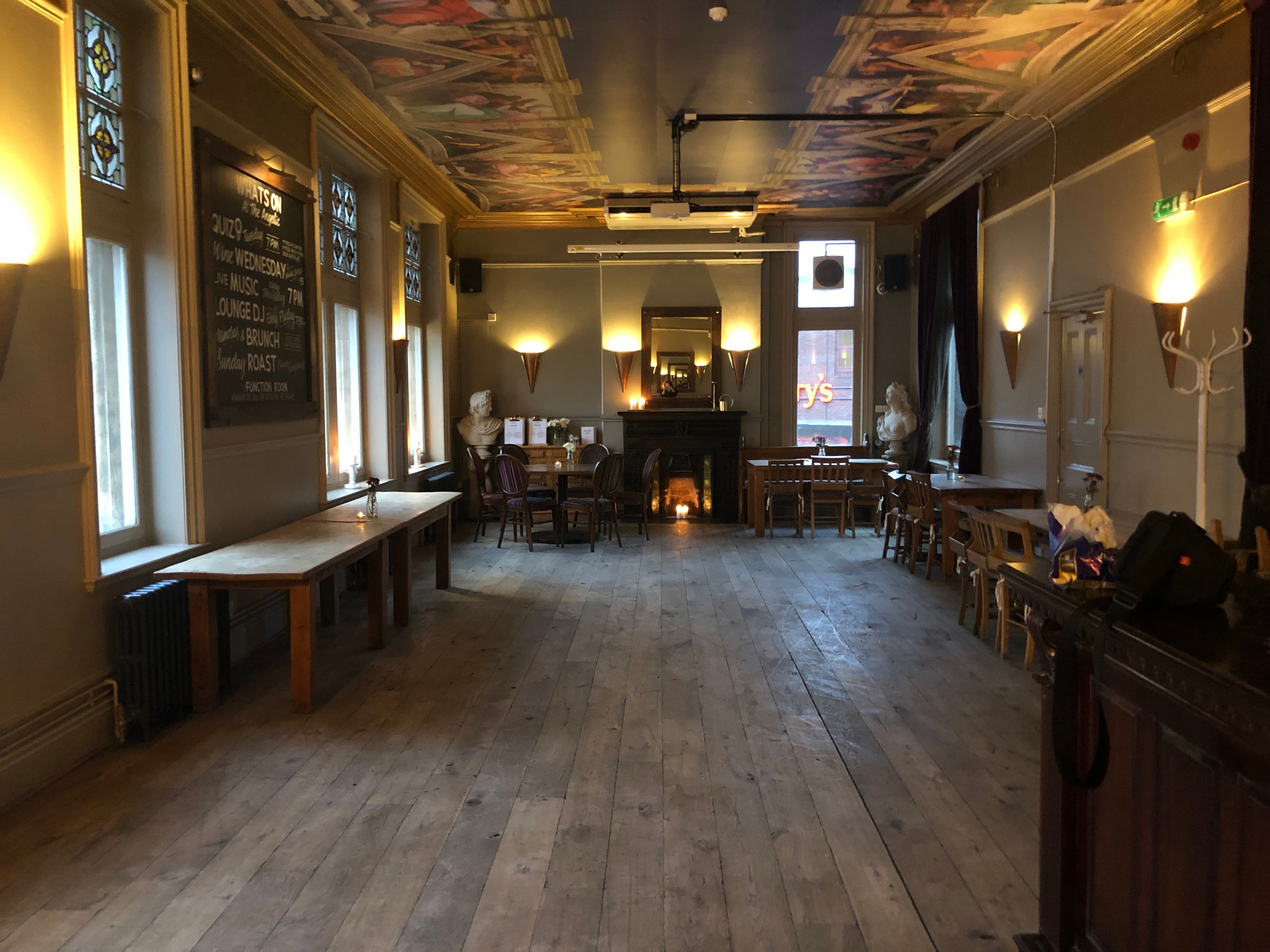 Spacious function room with wooden floors, ideal for workshops and receptions.