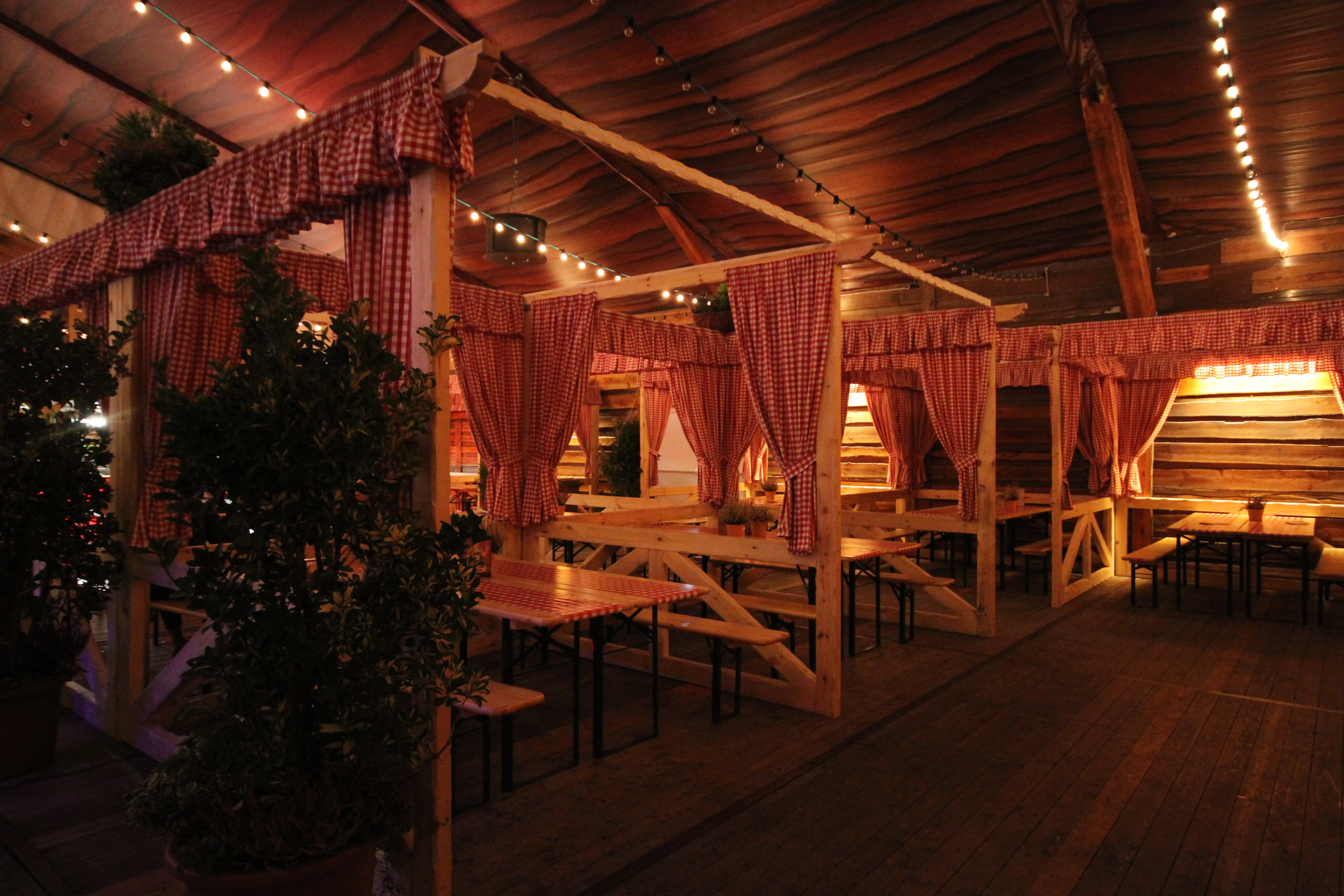 Charming Bavarian event space with rustic wood and cozy seating for intimate gatherings.