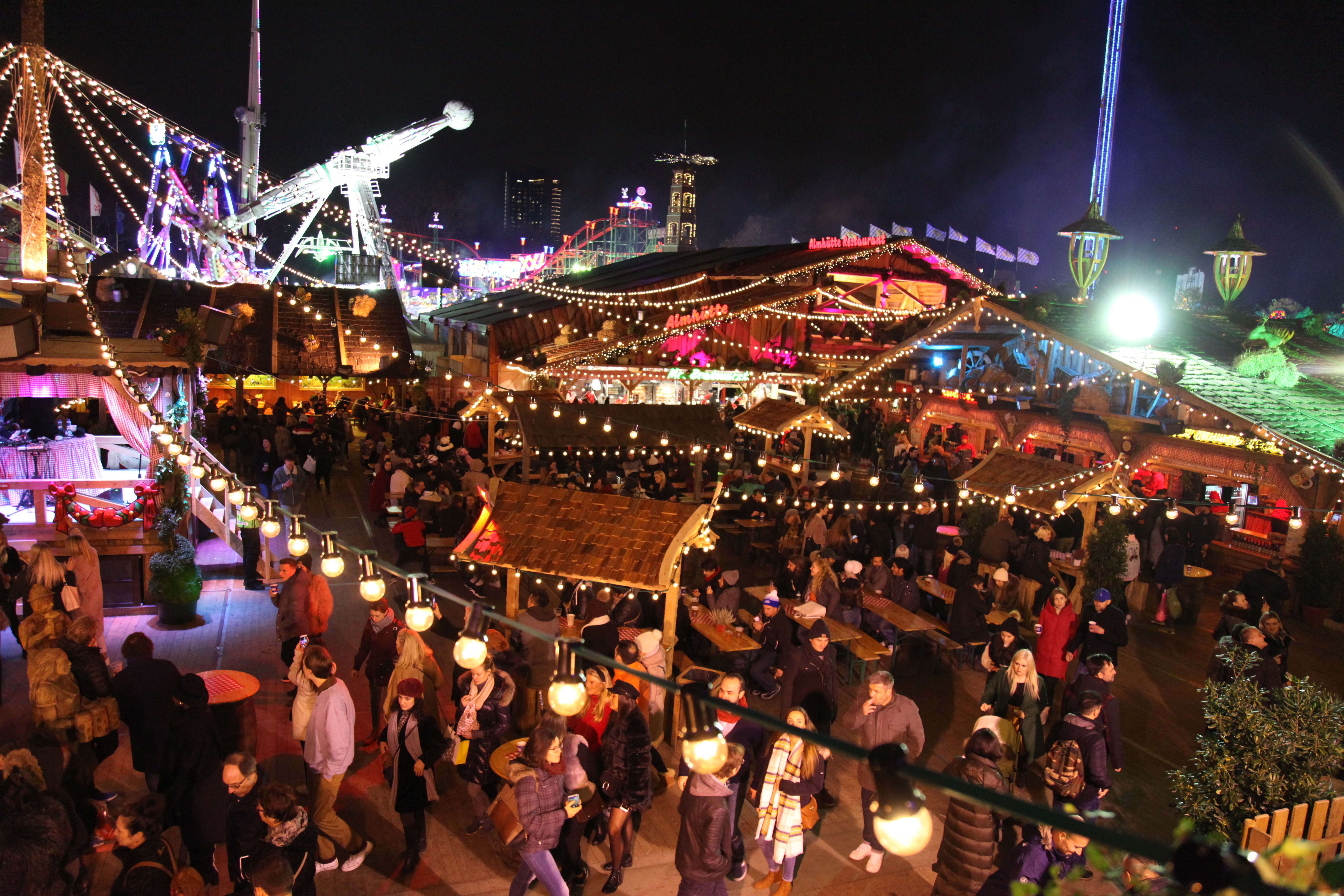 Vibrant outdoor event at Cafe Bavaria with colorful lights and festive decorations.