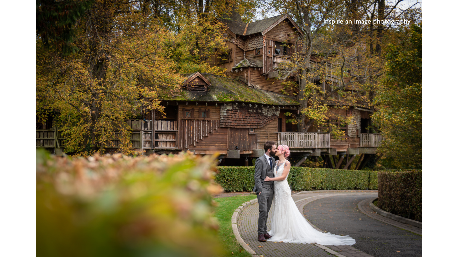 Couple embracing in The Treehouse, Alnwick Garden, perfect for autumn weddings.