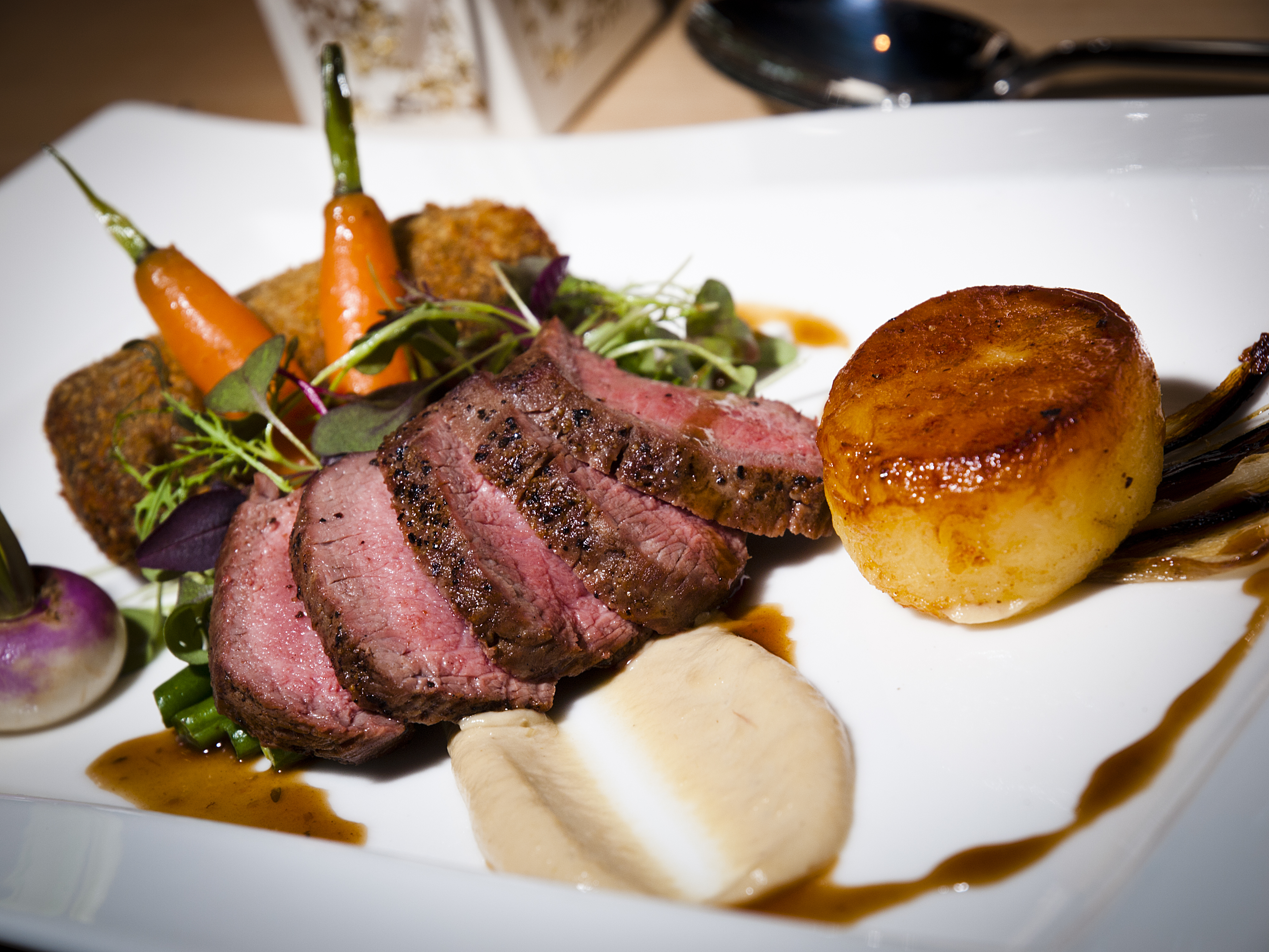 Gourmet beef dish with carrots and potato at The Treehouse, Alnwick Garden event dining.