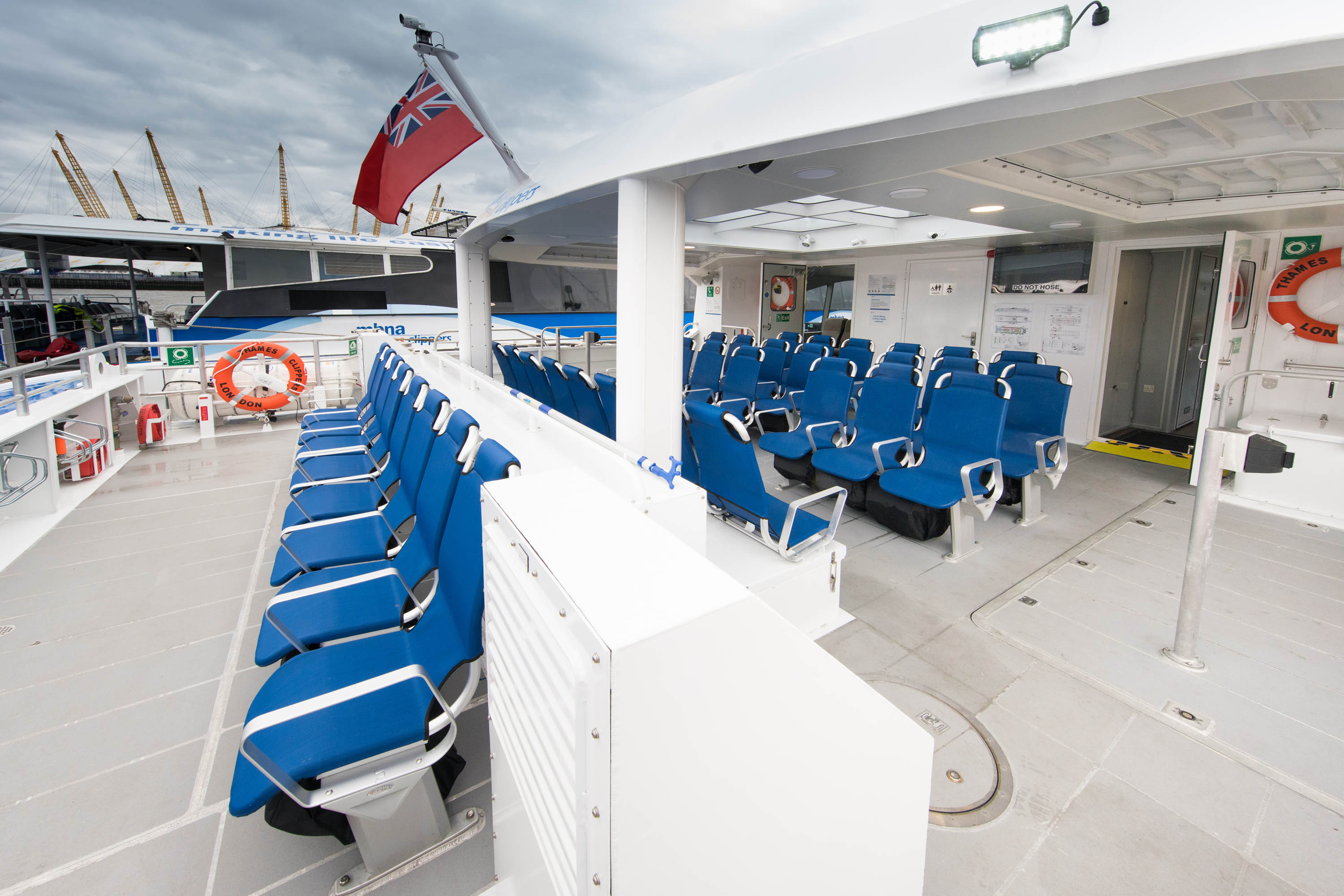 Modern event space on Venus Clipper with blue seating for meetings and networking.