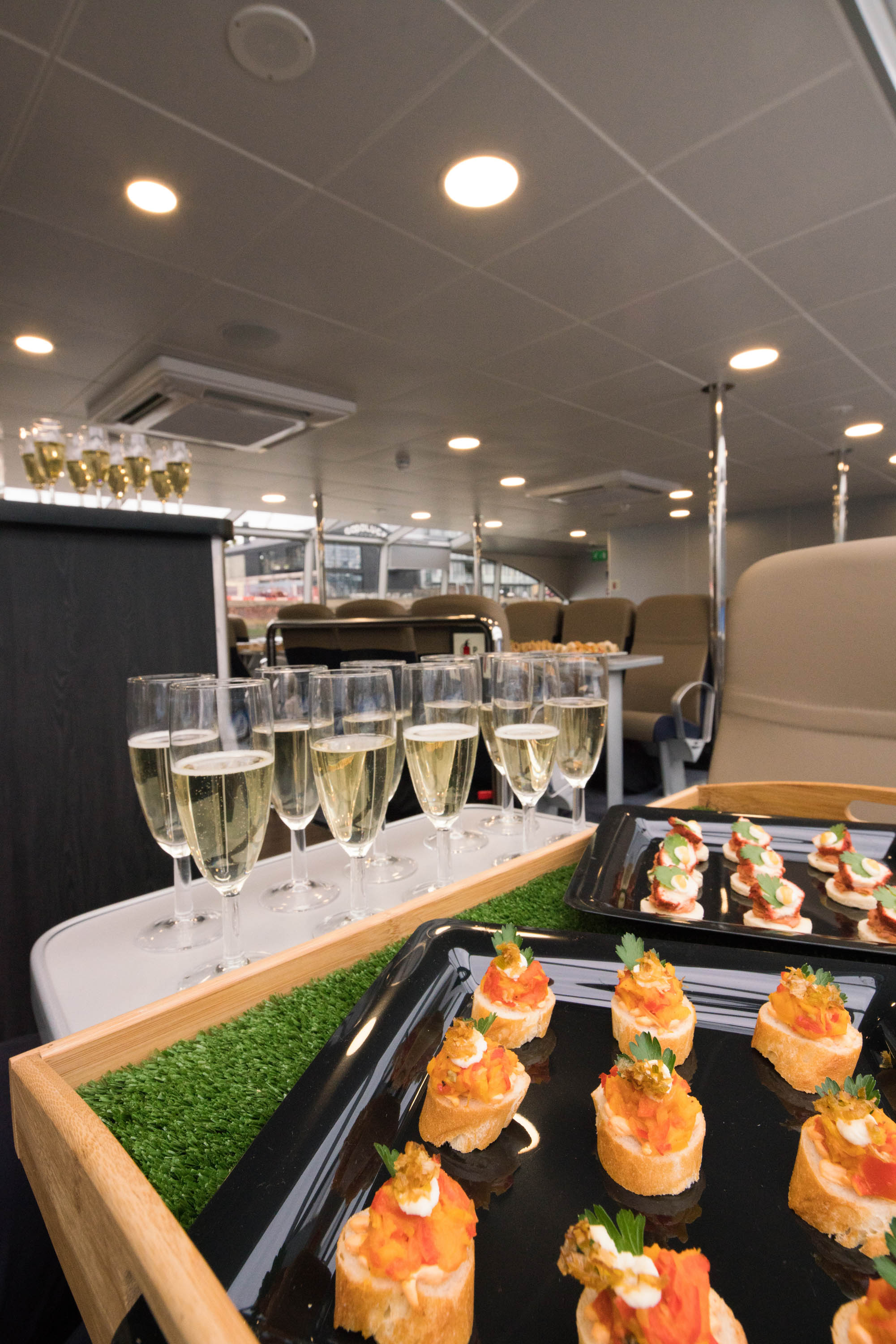 Elegant champagne flutes and canapés at a premium networking reception event.