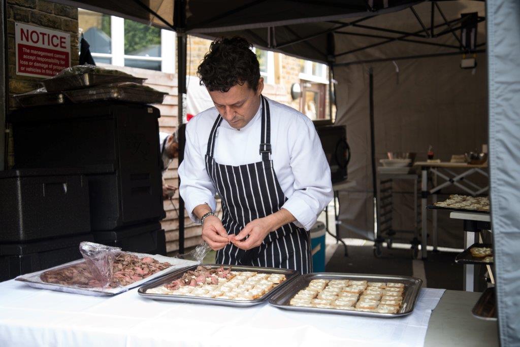 Chef preparing hors d'oeuvres at Hammersmith Club for outdoor event catering.