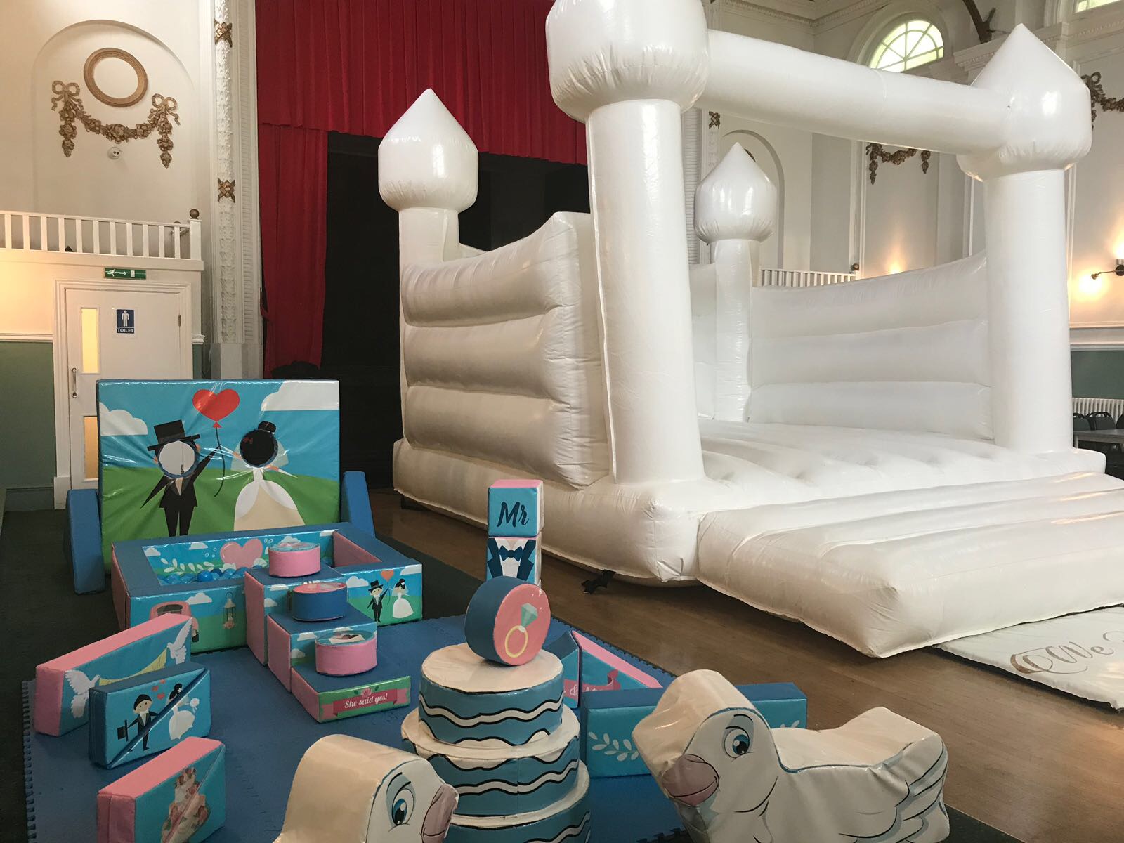 Whimsical Hammersmith Club Main Hall with inflatable castle for children's parties.