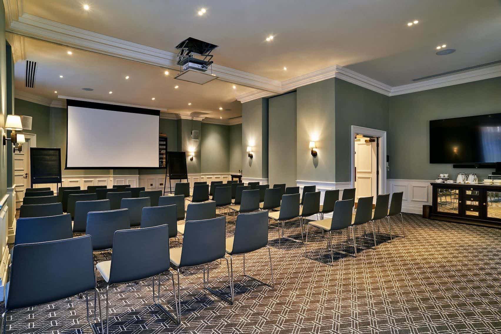 Meeting room at Kimpton Fitzroy London with projection screen for events and presentations.