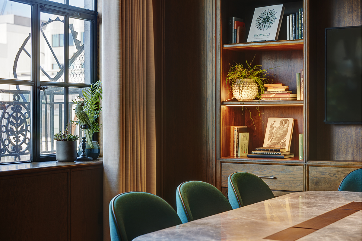 Private dining room with marble table and plush chairs for meetings or gatherings.