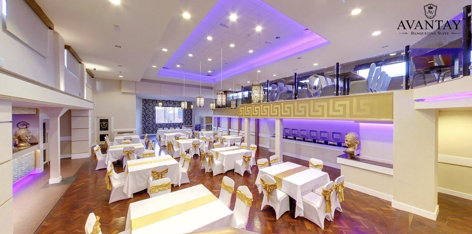 Elegant Avantay banqueting suite with white tables and gold accents for corporate events.