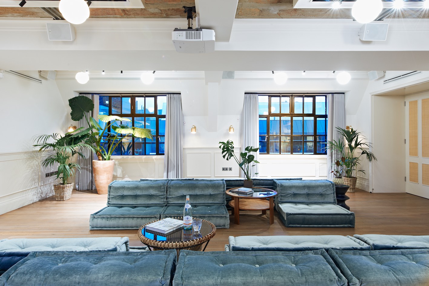 Stylish meeting space with natural light and greenery for collaborative events.