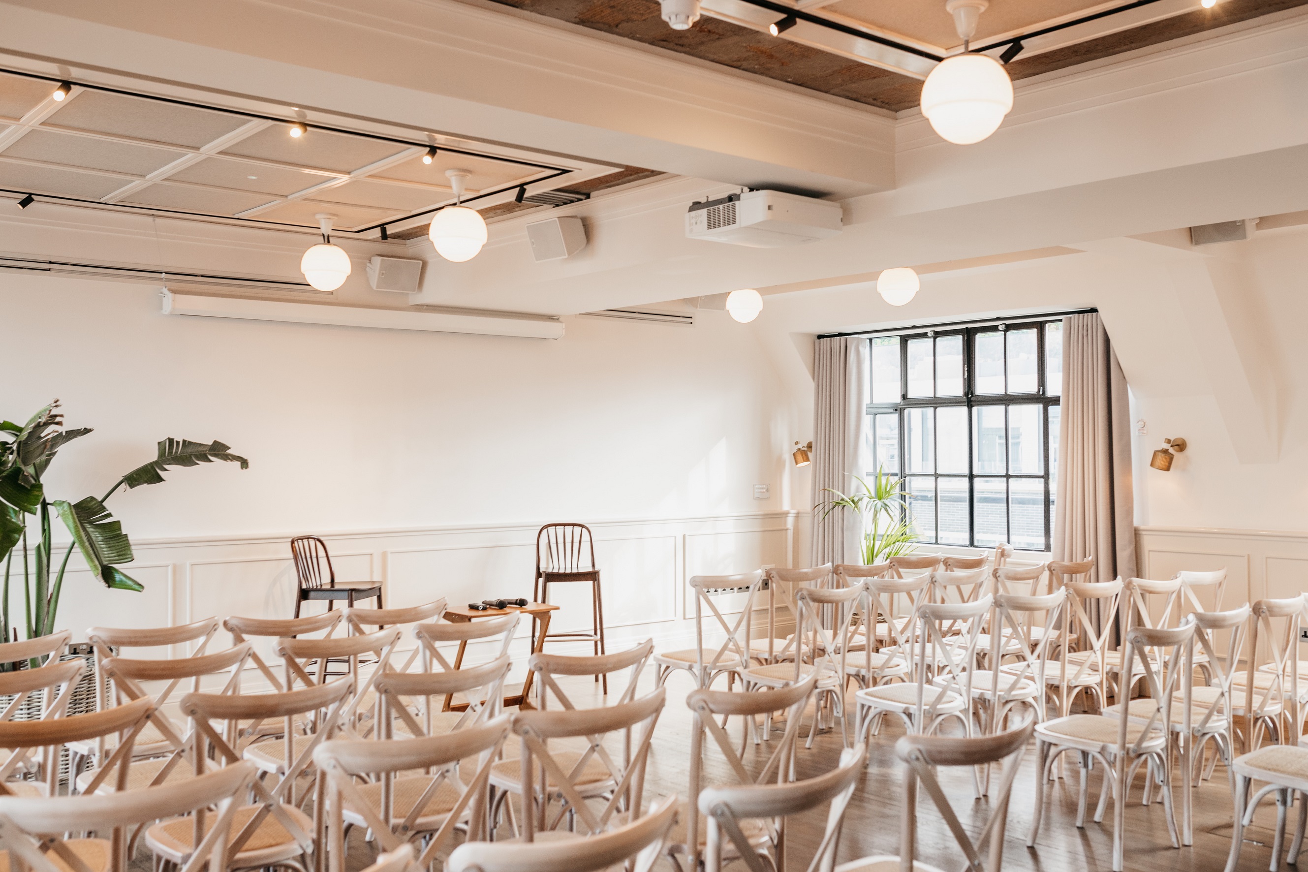 Loft and Gallery event space with white chairs, perfect for workshops and meetings.