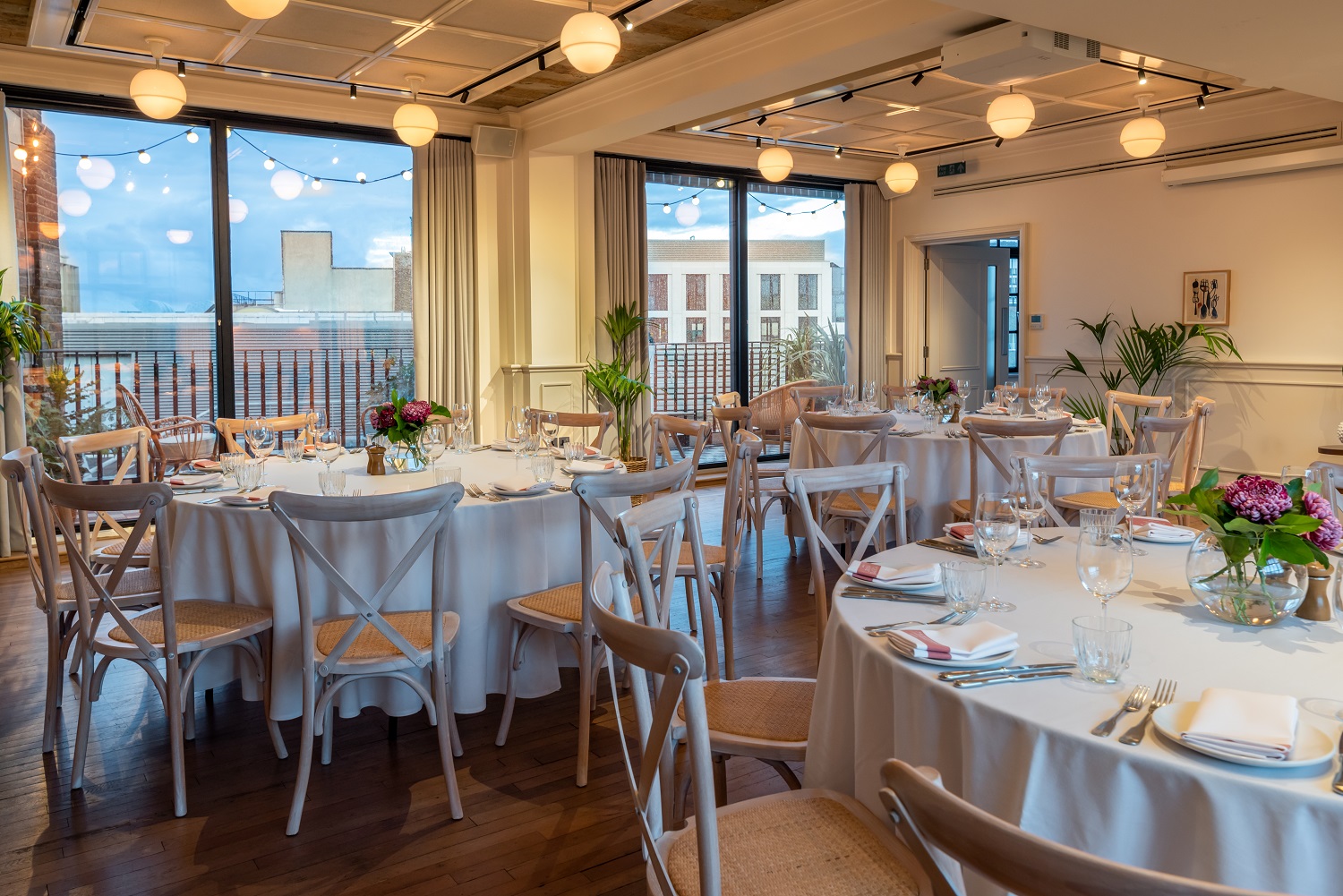 Elegant event space with floral centerpieces, ideal for corporate dinners and gatherings.