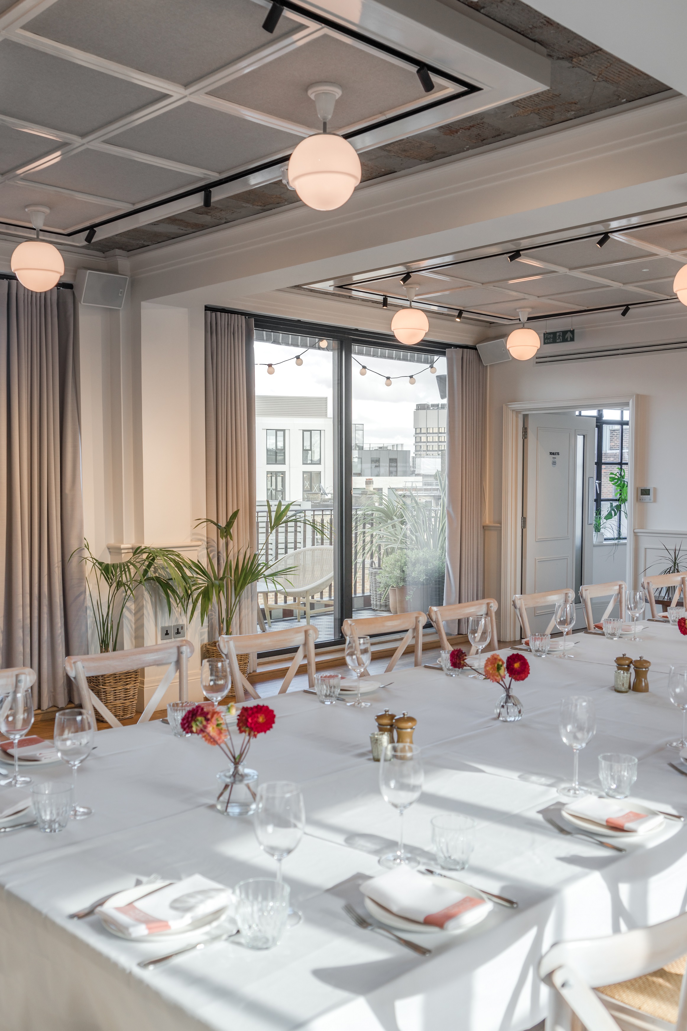 Loft and Gallery event space with elegant table setup for meetings and gatherings.
