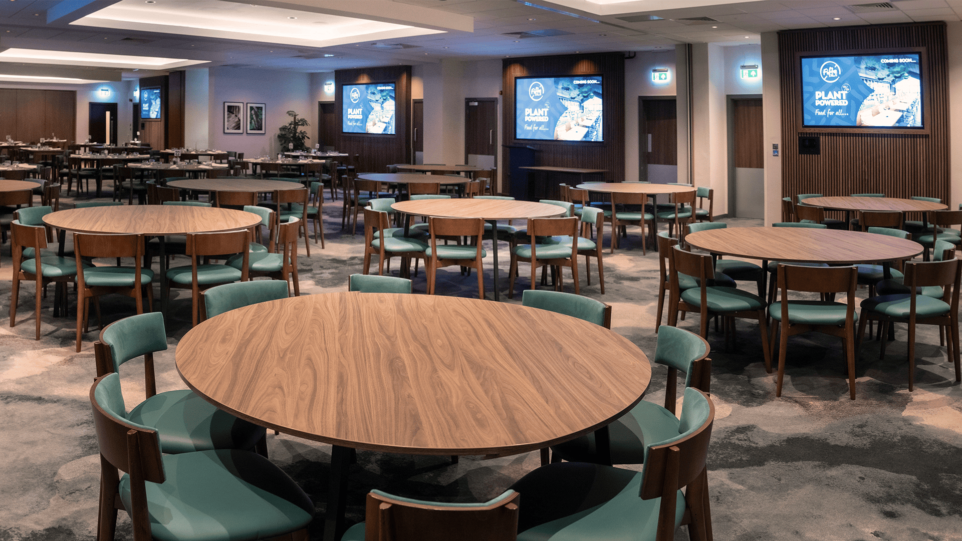 Large meeting space with round tables at Burleigh Court for conferences and networking.
