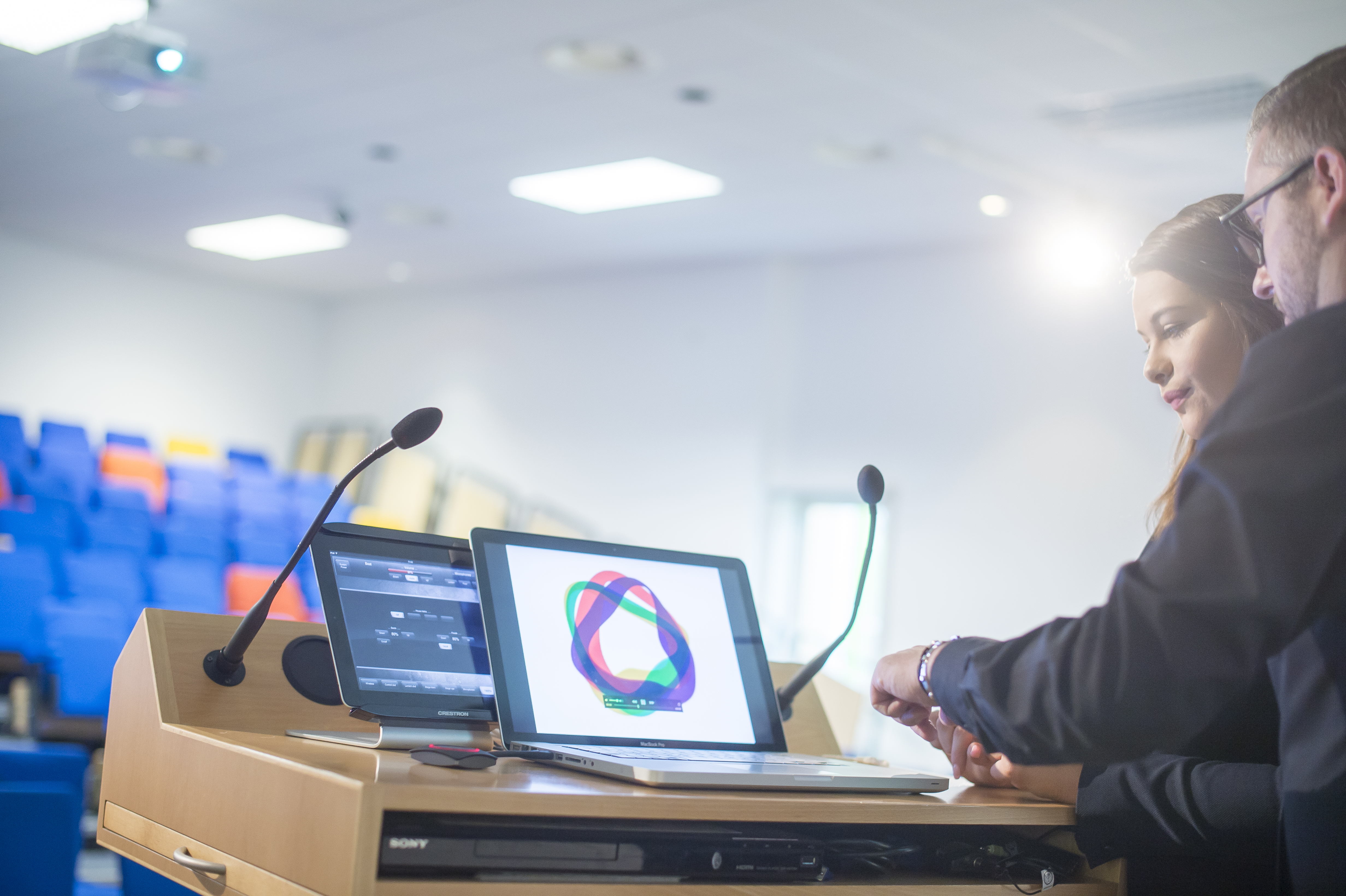 Stephenson Lecture Theatre setup for a professional presentation with multiple screens.