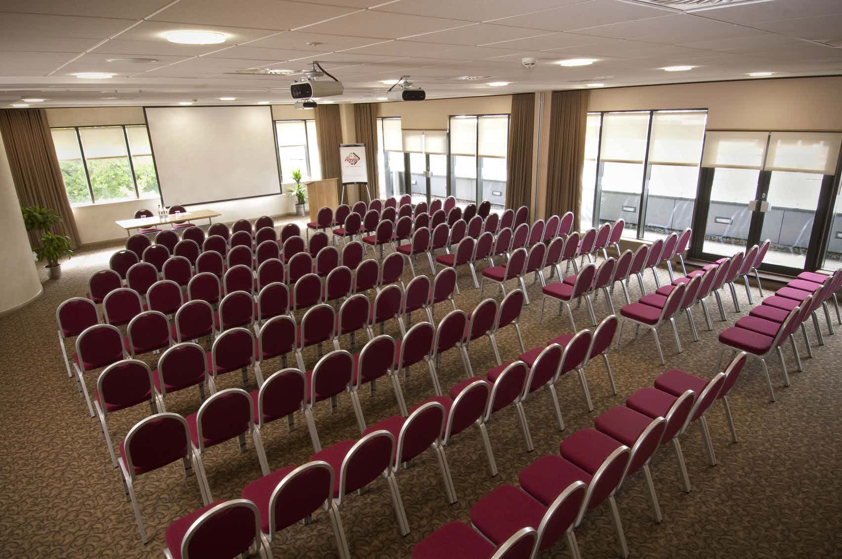 Meeting space at Future Inn Bristol with burgundy chairs, ideal for workshops and presentations.