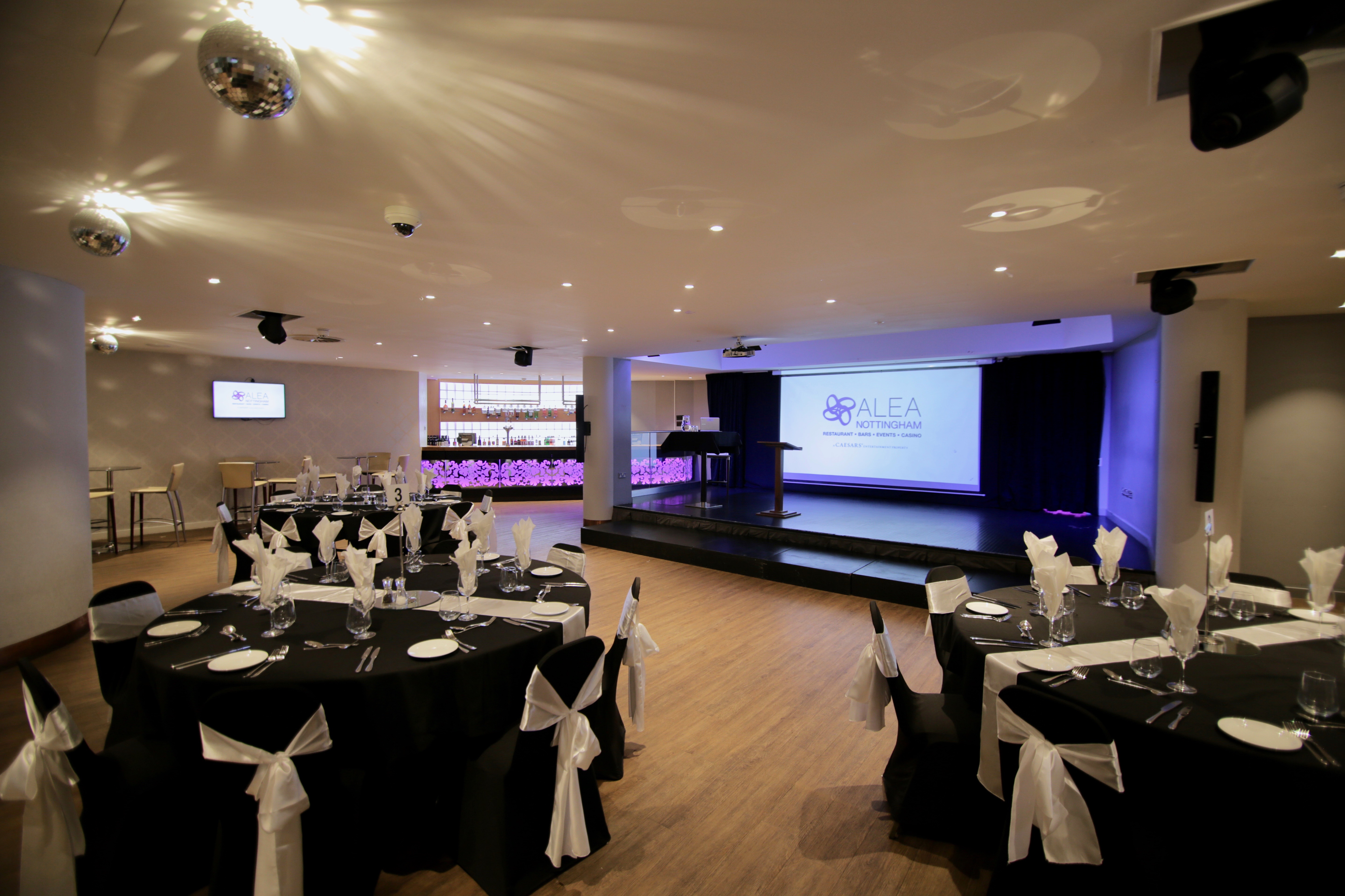 Elegant event space in Alea Casino with round tables, ideal for conferences and celebrations.